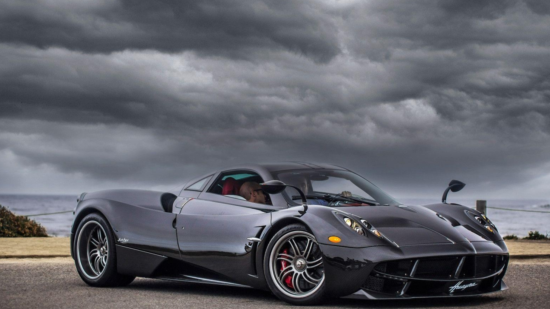 Pagani Huayra, Exposed carbon fiber bodywork, Dark storm clouds over ocean, Full HD Desktop wallpaper