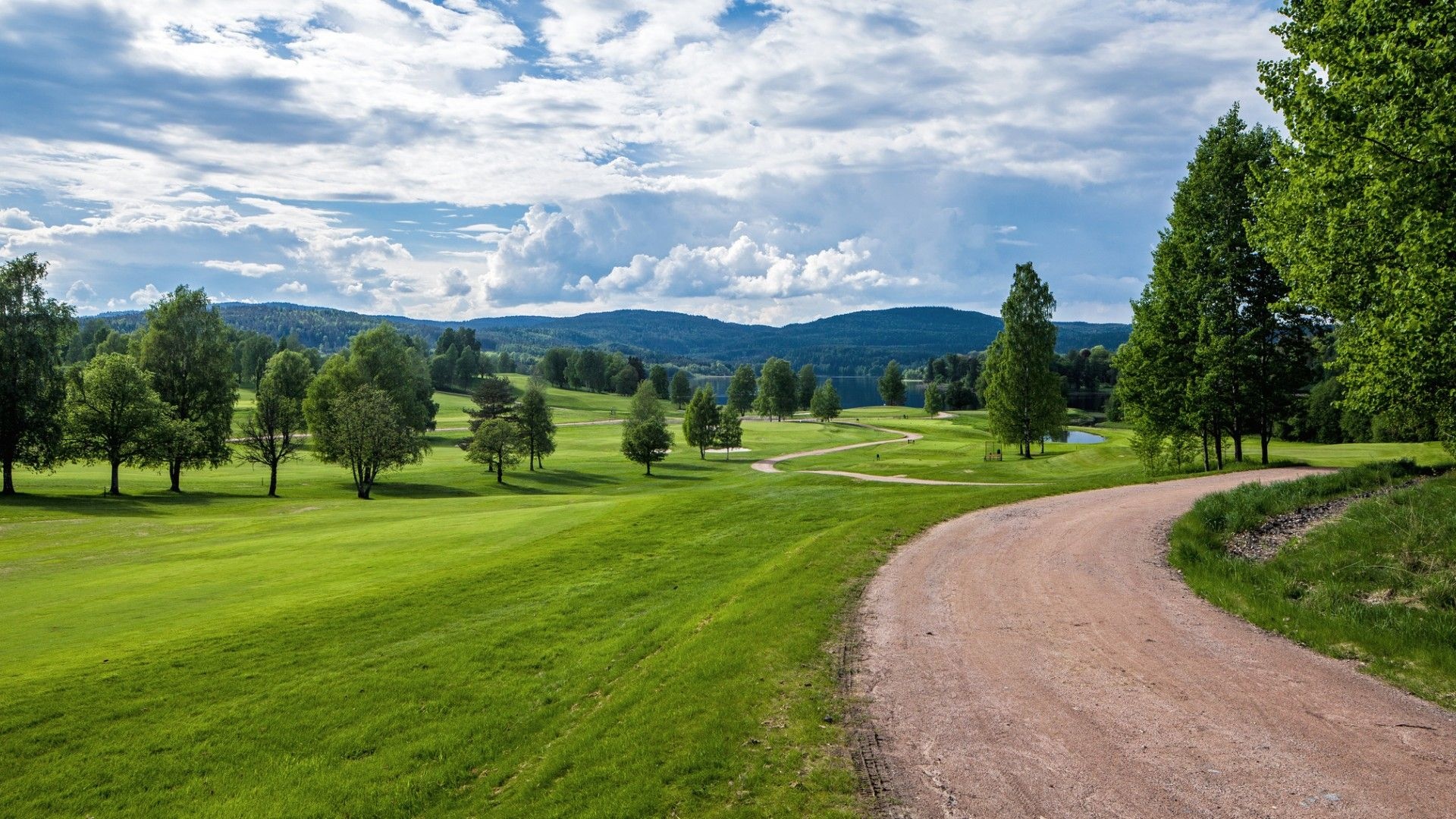 golf course fairway, winding gravel road, distant lake and hills, Full HD Desktop wallpaper