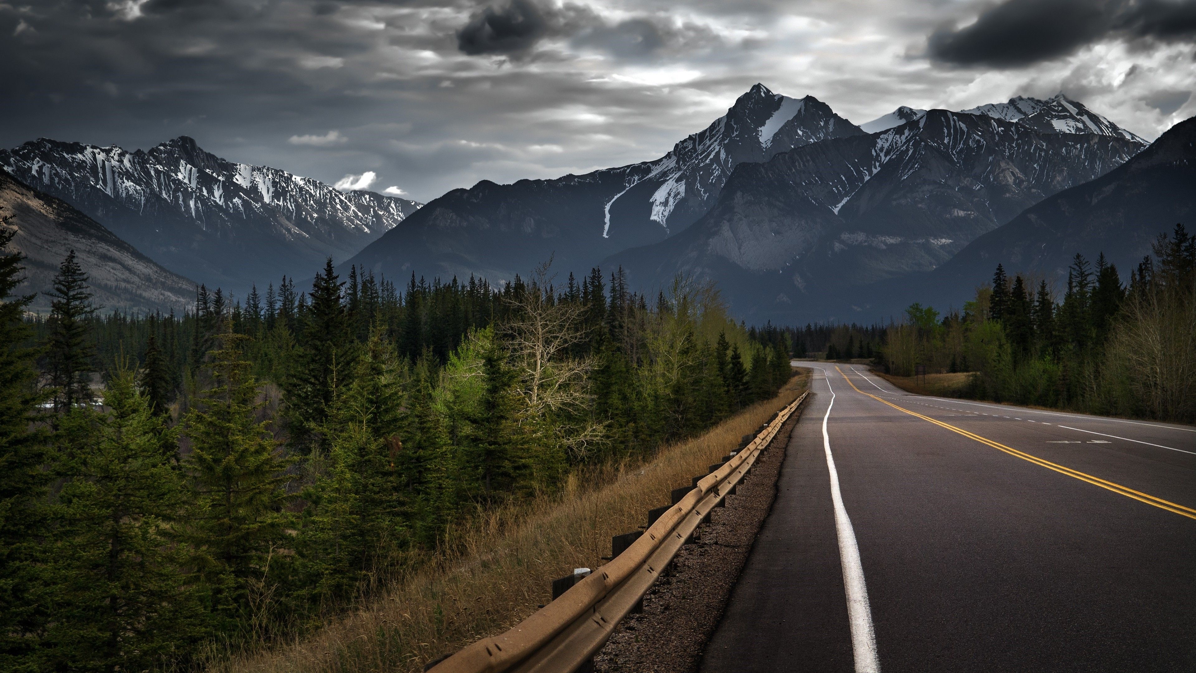 Canadian Rocky Mountains, two-lane mountain highway, rusty roadside guardrail, 4K Desktop wallpaper
