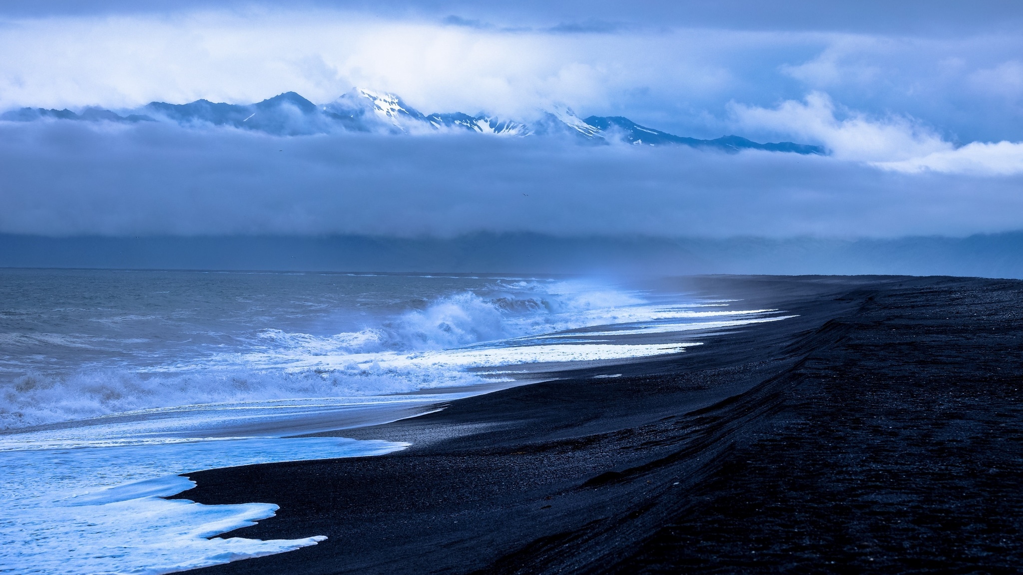 black sand beach, snow-capped coastal mountains, crashing ocean surf, HD Desktop wallpaper