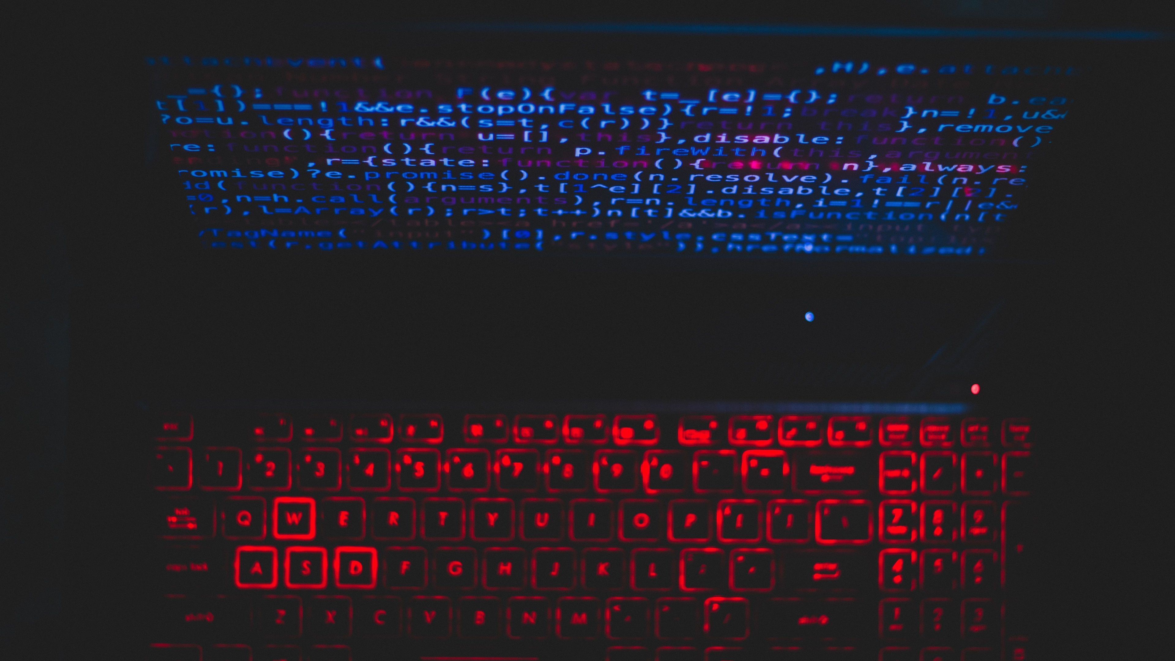 jQuery source code screen, red backlit laptop keyboard, dark coding setup, 4K Desktop wallpaper