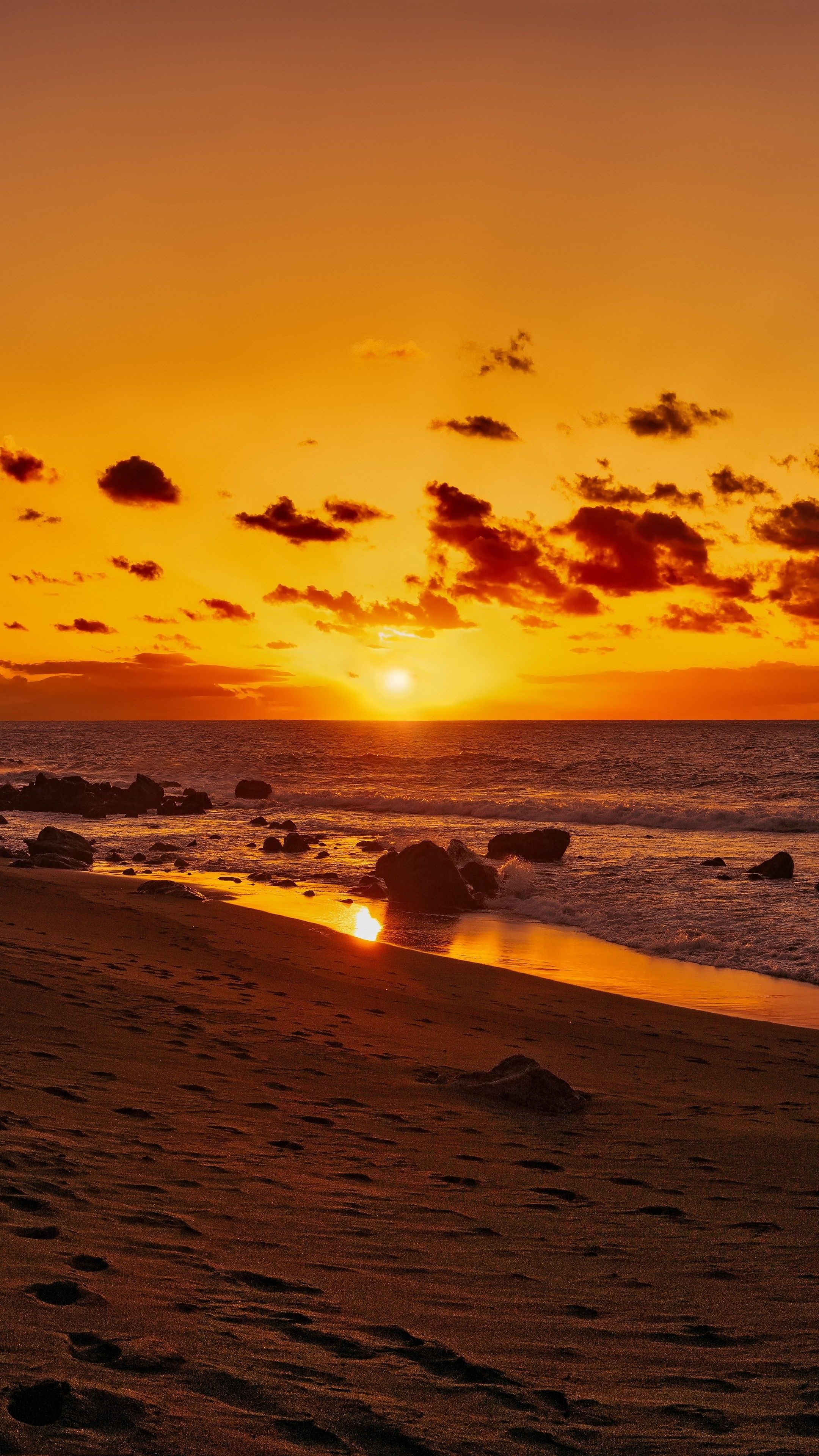 Golden sunset over ocean, Rocky beach shoreline, Orange sky with clouds, 4K Phone wallpaper