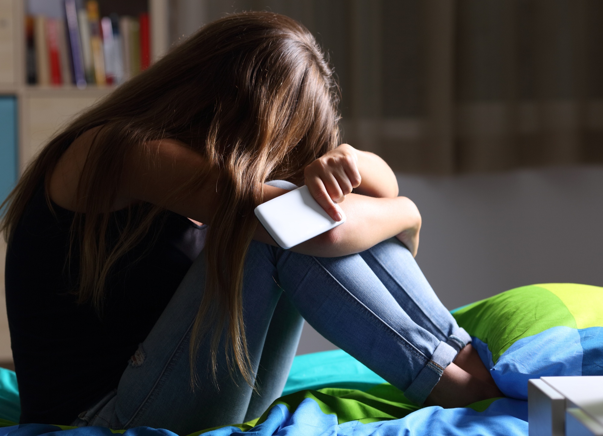 Crying girl holding smartphone, White mobile phone, Darkened bedroom, HD Desktop wallpaper