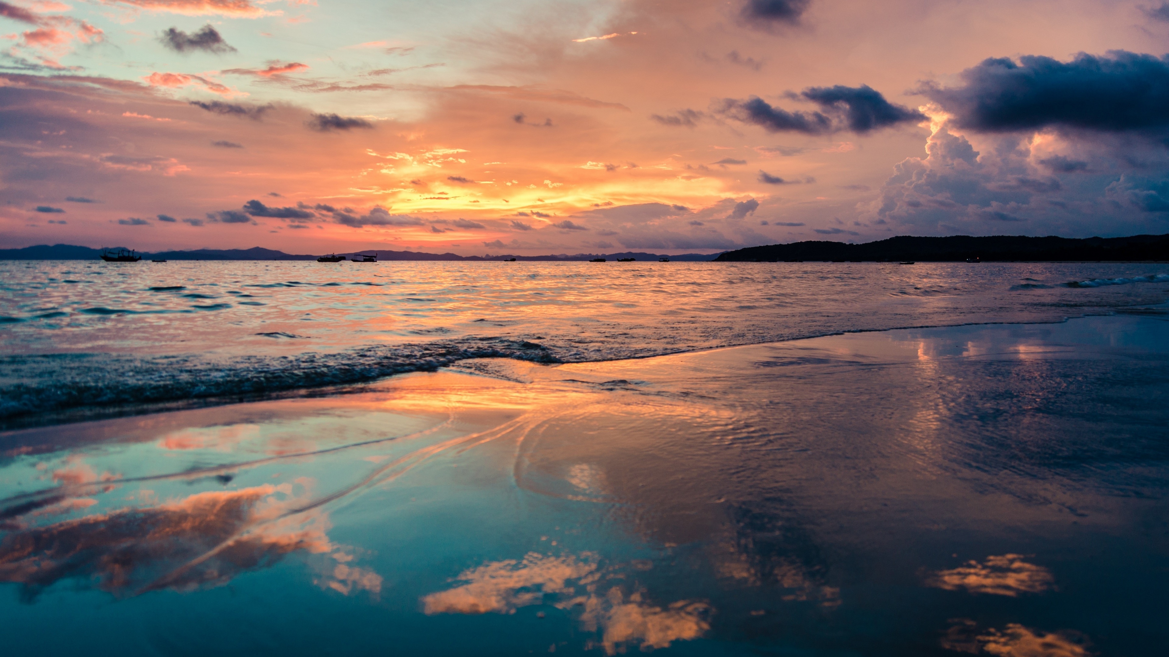wet sand beach reflection, vibrant dusk sky clouds, distant silhouetted boats, 4K Desktop wallpaper
