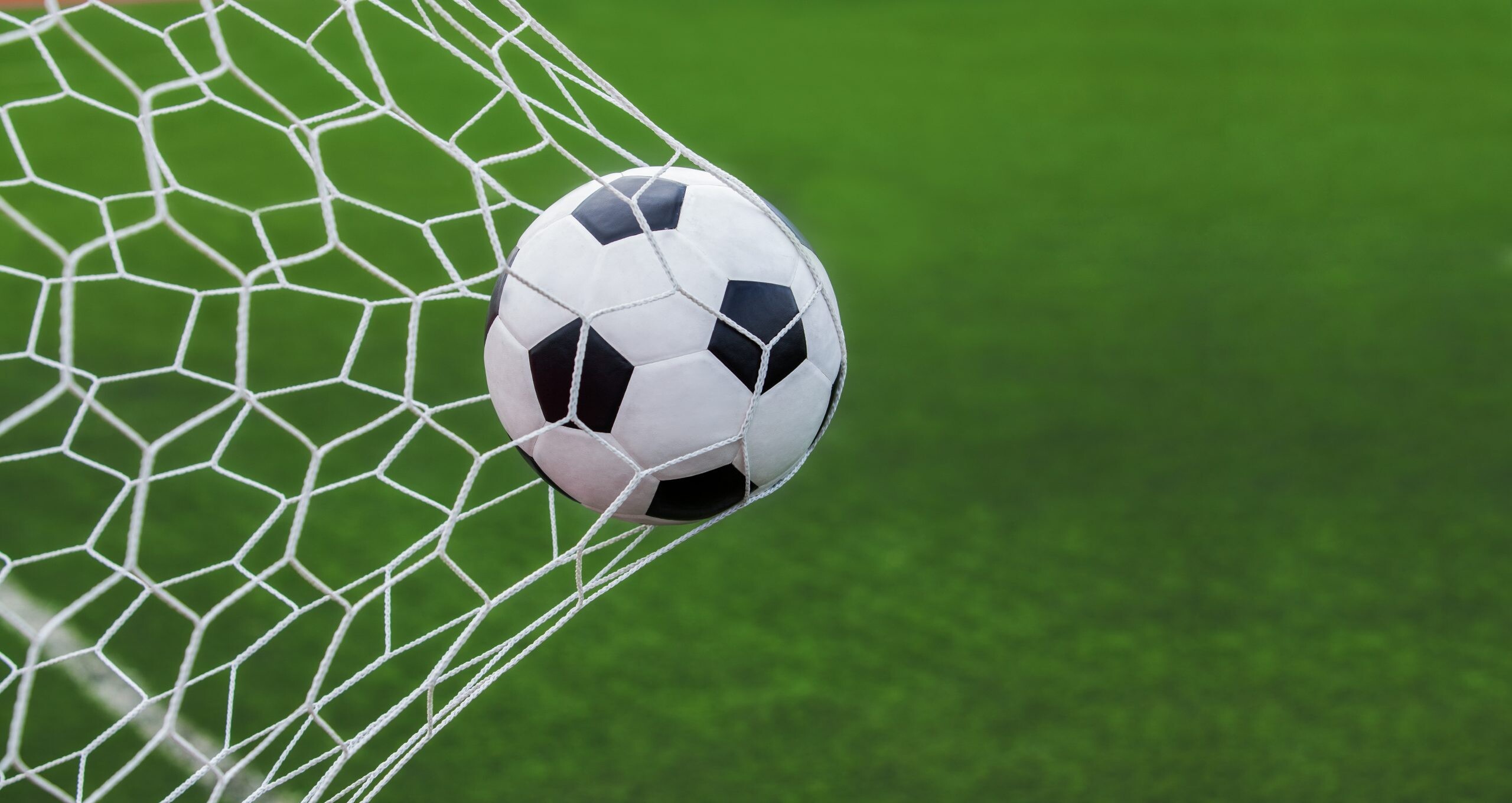 Football soccer ball in goal, Striker's glory, Net's triumph, Sportsmanship captured, 2560x1360 HD Desktop