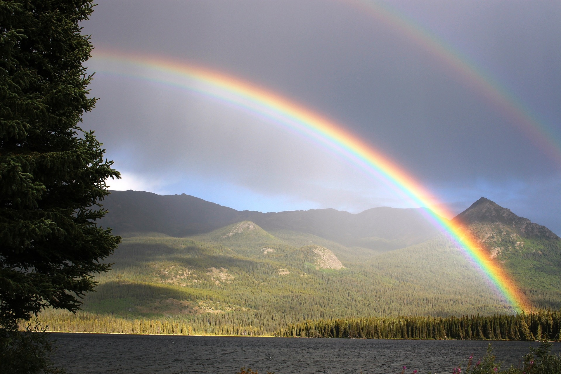 Vivid double rainbow, Forested mountain landscape, Calm lake shoreline, HD Desktop wallpaper