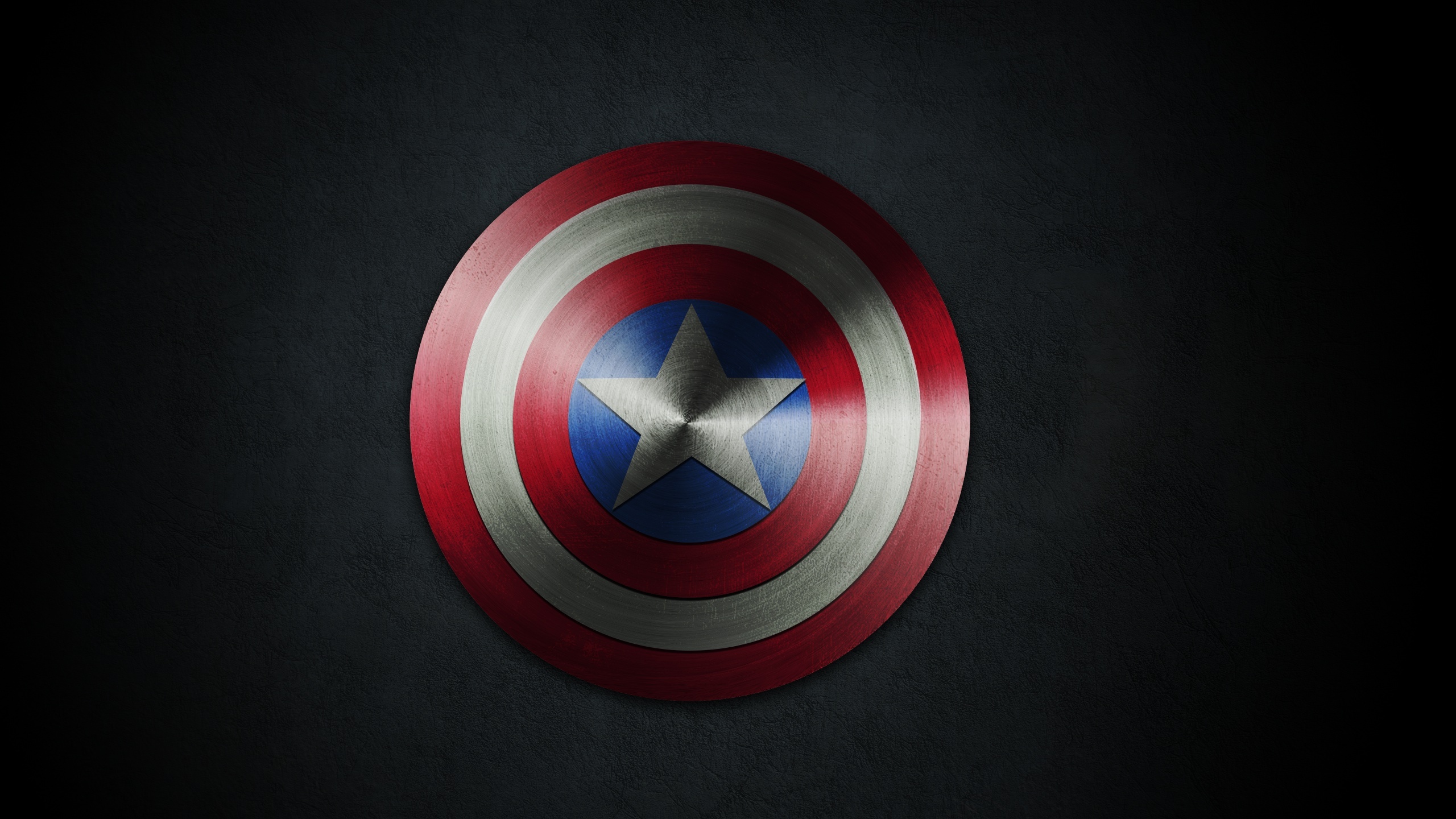 Captain America's vibranium shield, brushed circular star emblem, dark textured wall, HD Desktop wallpaper