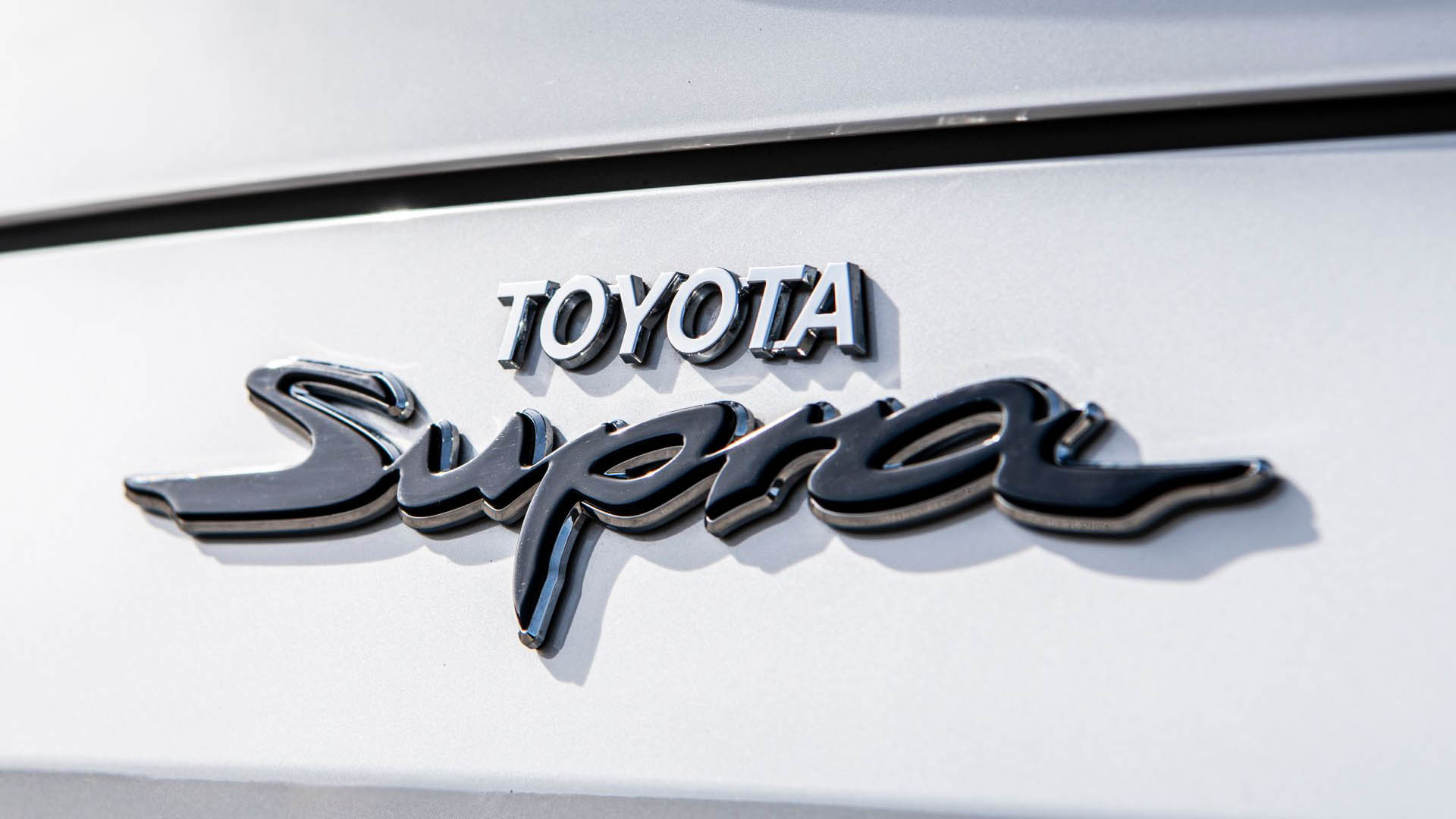 Toyota Supra badge, Script Supra emblem, White car body panel, Full HD Desktop wallpaper