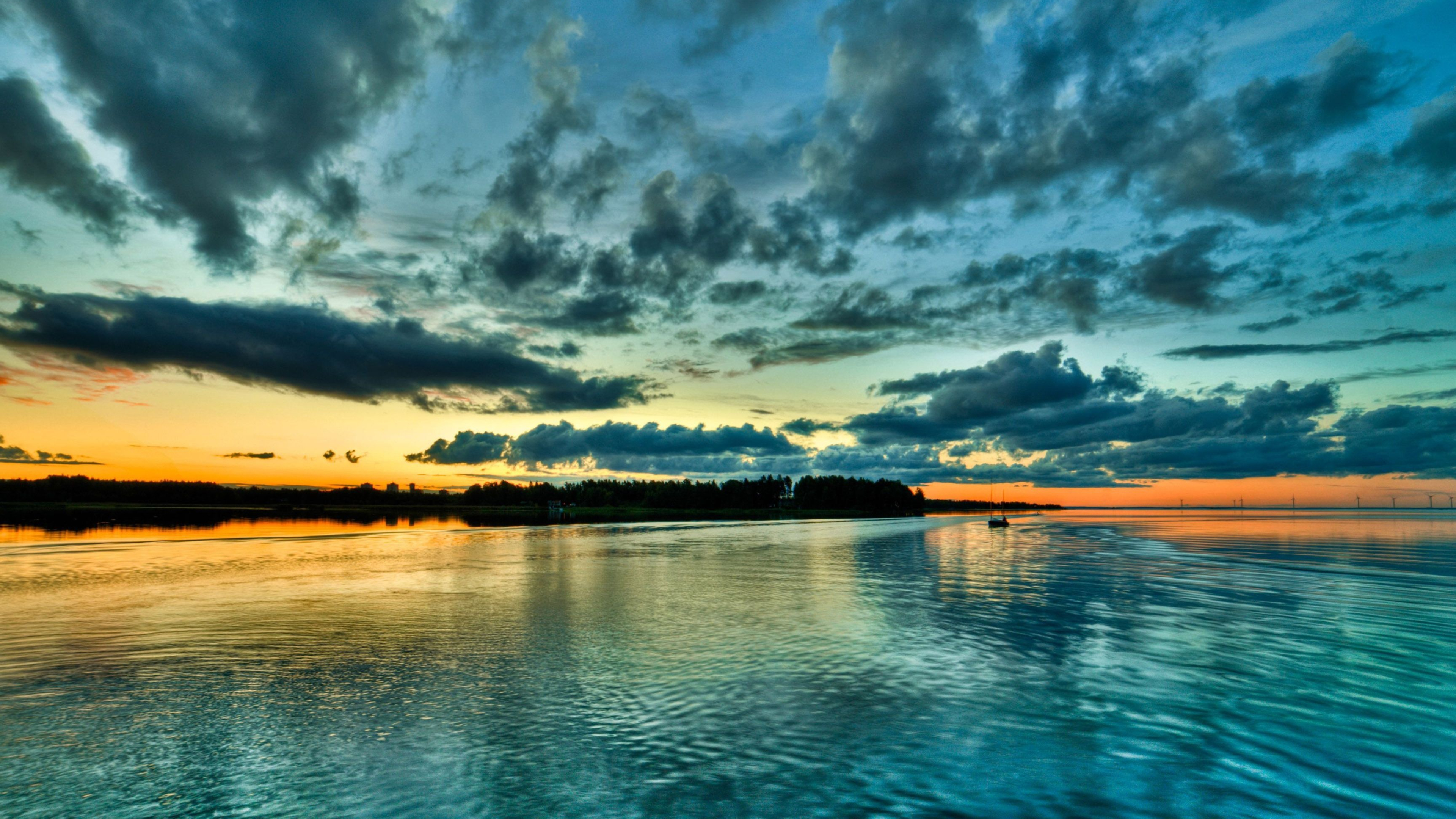 distant small boat, silhouetted shoreline forest, twilight sky cloud reflections, 4K Desktop wallpaper