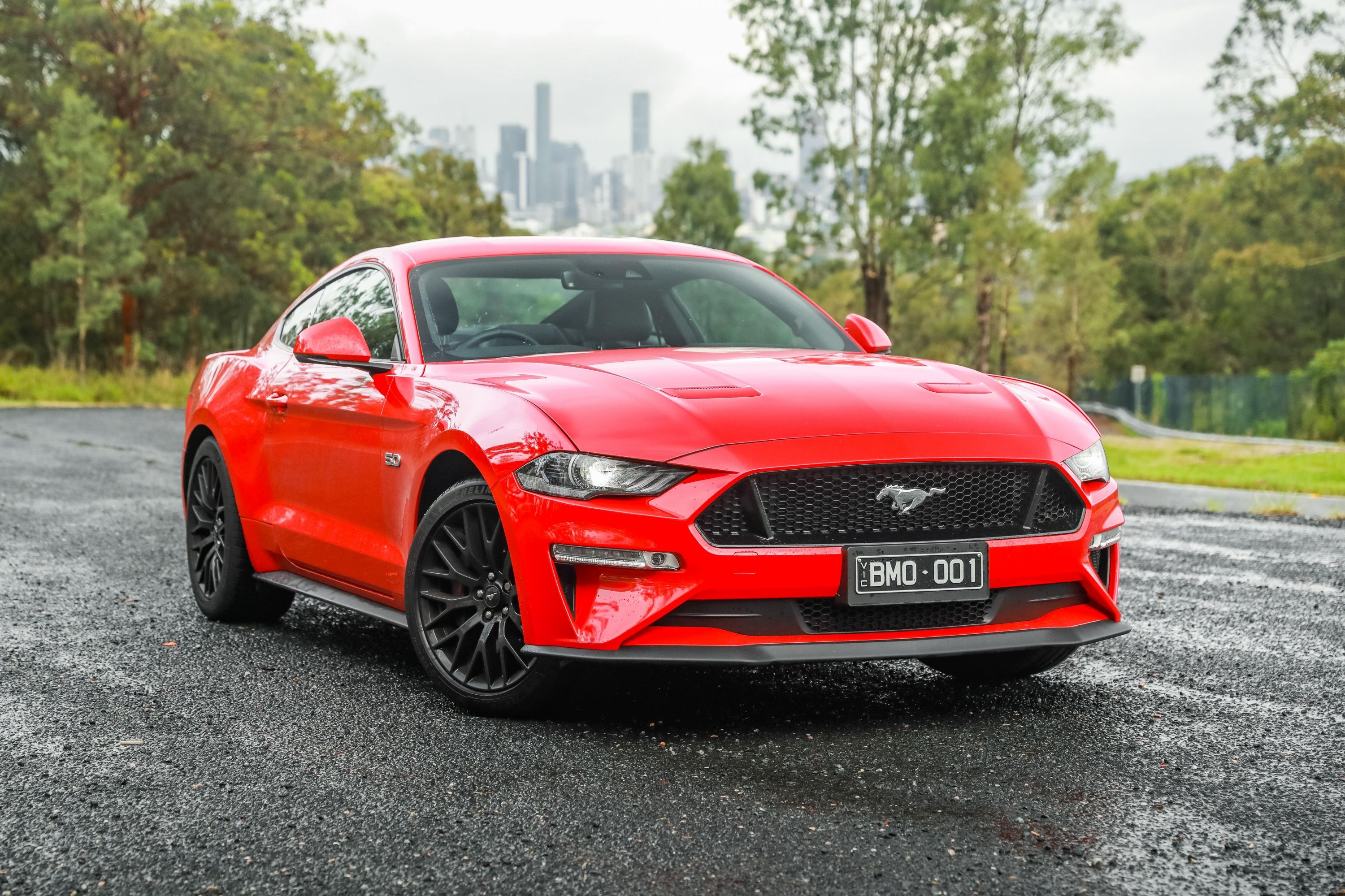 Red Ford Mustang GT, Distant city skyline, Wet asphalt ground, HD Desktop wallpaper