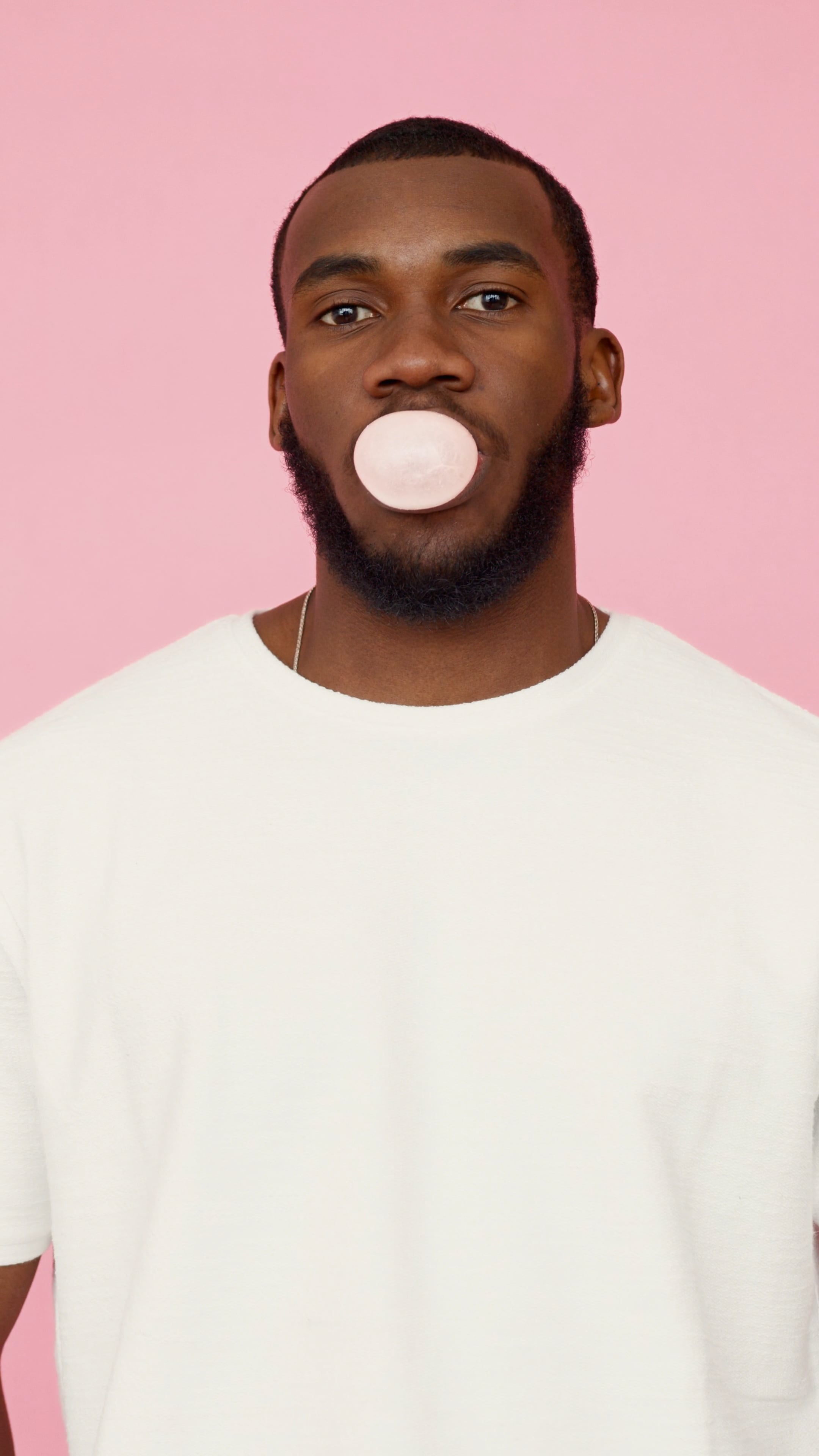 Man blowing bubble gum, Fun and entertaining, Bubble-blowing amazement, Playful enjoyment, 2160x3840 4K Phone