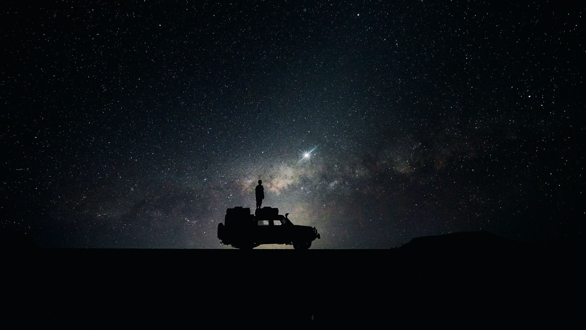 person standing on roof, off-road expedition vehicle silhouette, Milky Way night sky, Full HD Desktop wallpaper
