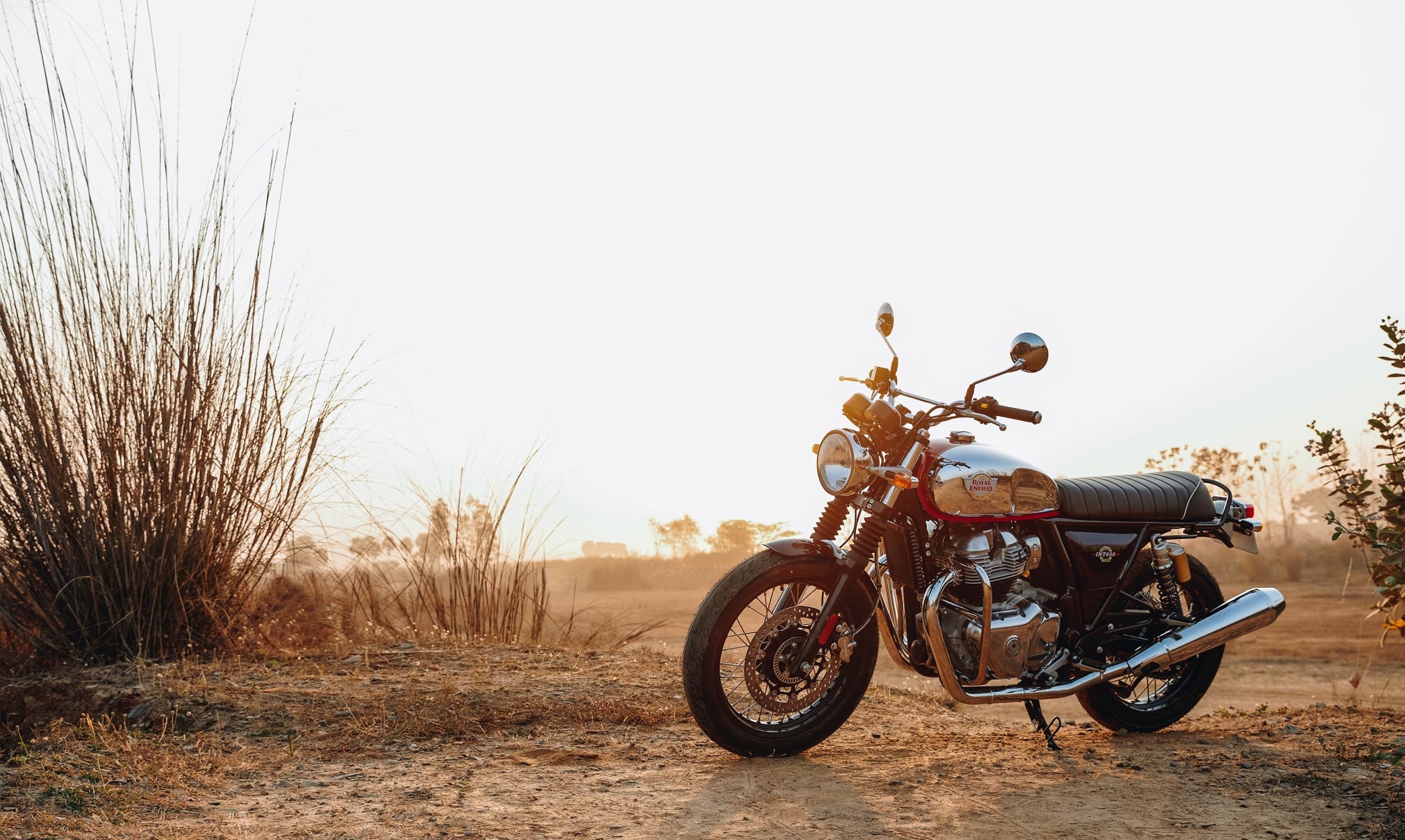 Royal Enfield Interceptor 650, chrome fuel tank, golden hour countryside, HD Desktop wallpaper