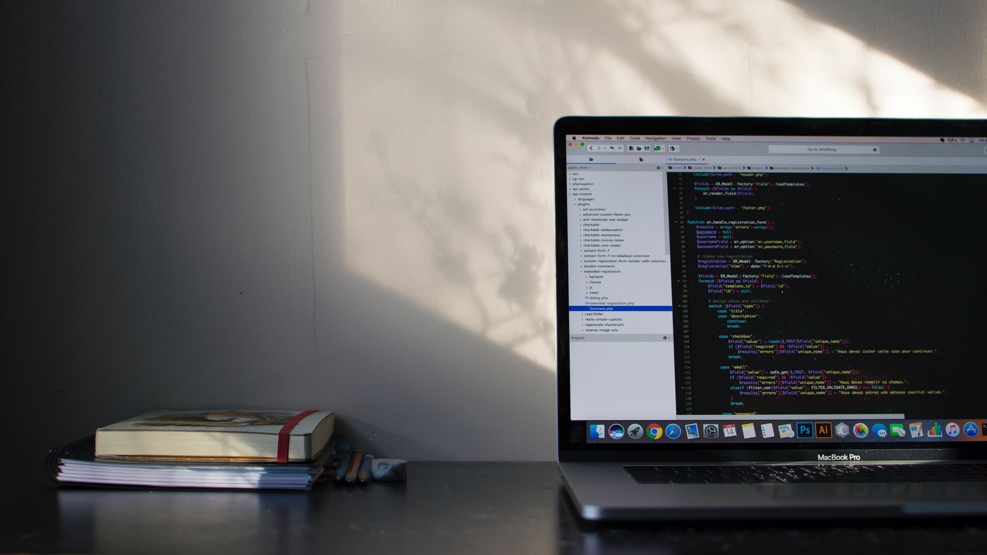 Apple MacBook Pro, Komodo Edit code editor, stack of notebooks, HD Desktop wallpaper