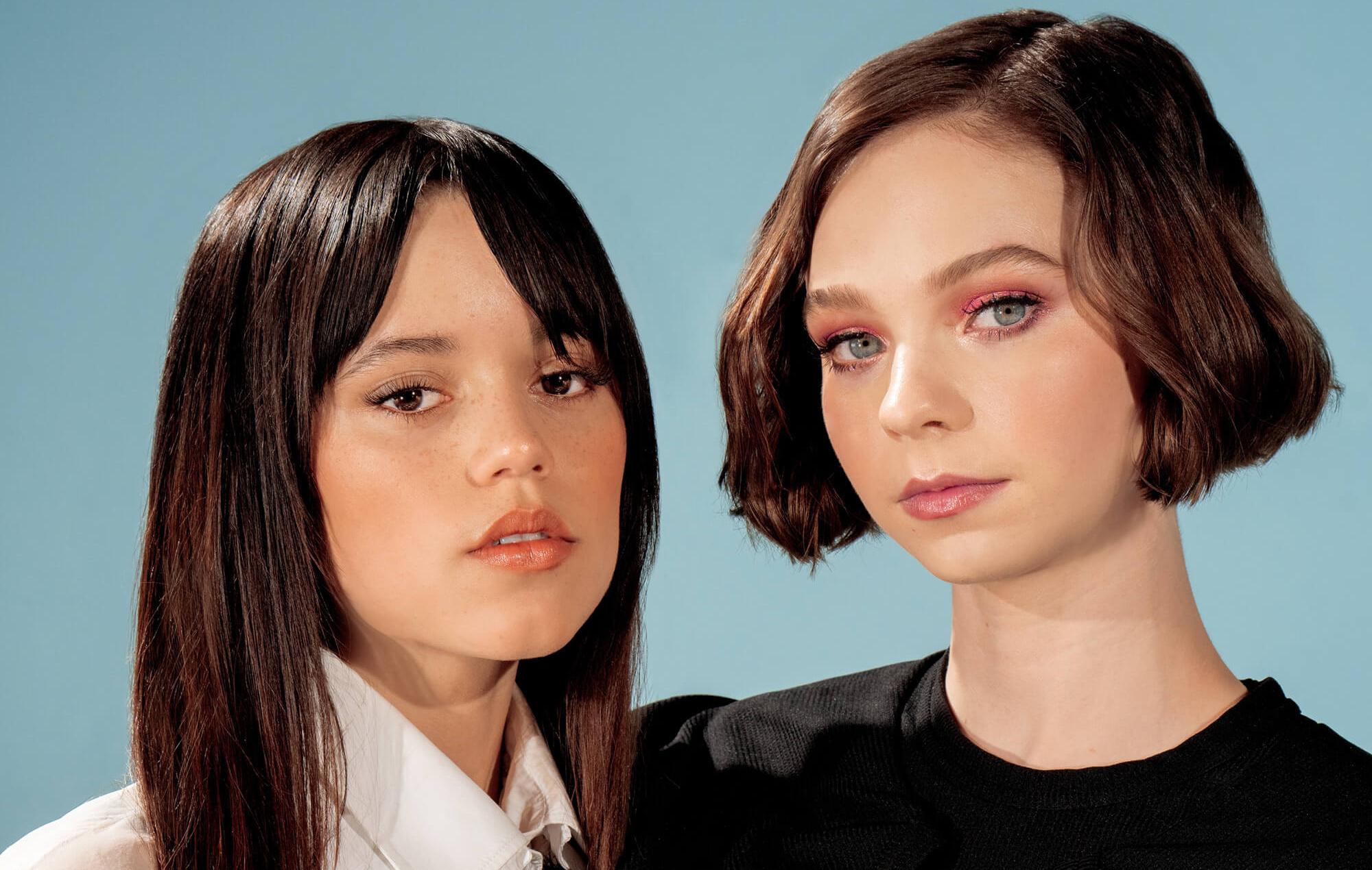 Emma Myers in black top, Jenna Ortega in white shirt, Pink graphic eye makeup, Pale blue studio backdrop, HD Desktop wallpaper