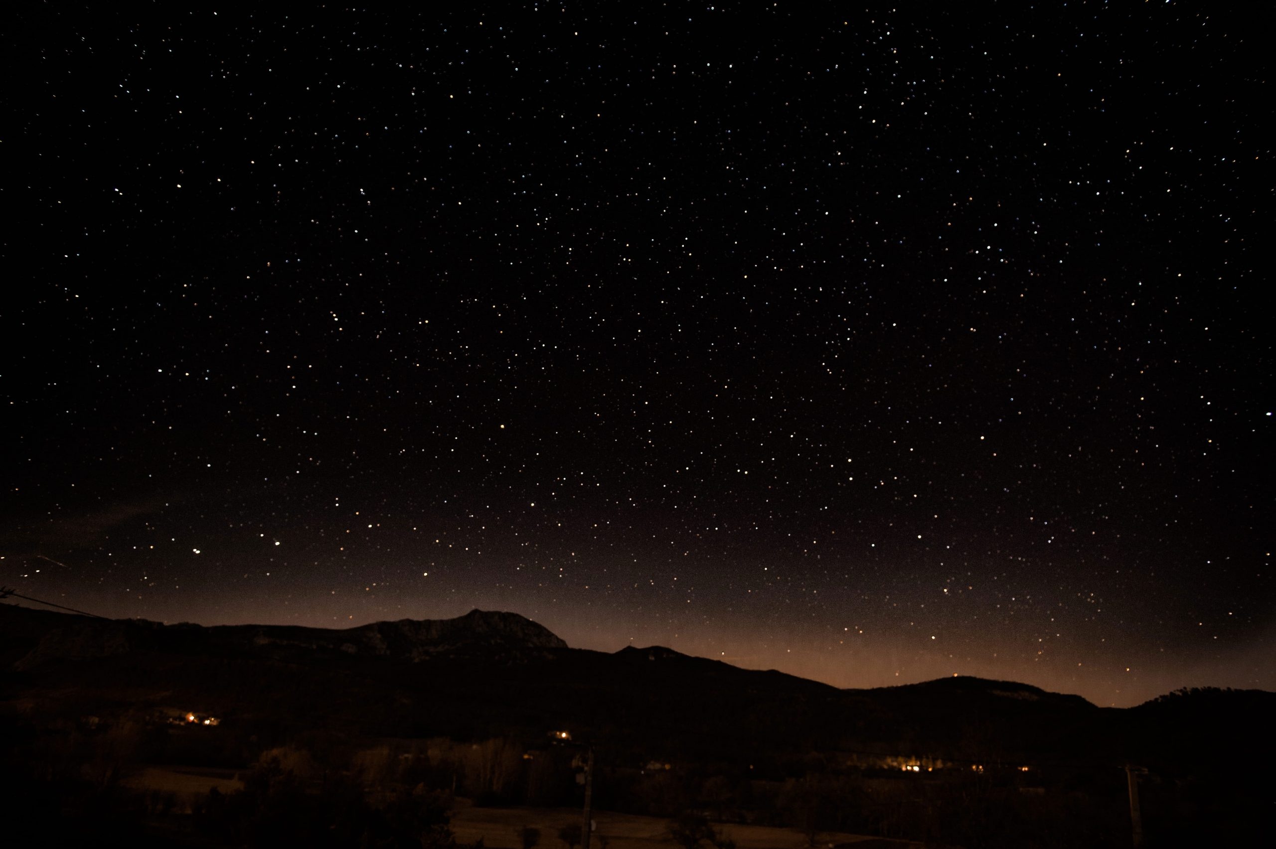 star-filled night sky, dark mountain silhouette, glowing horizon line, HD Desktop wallpaper