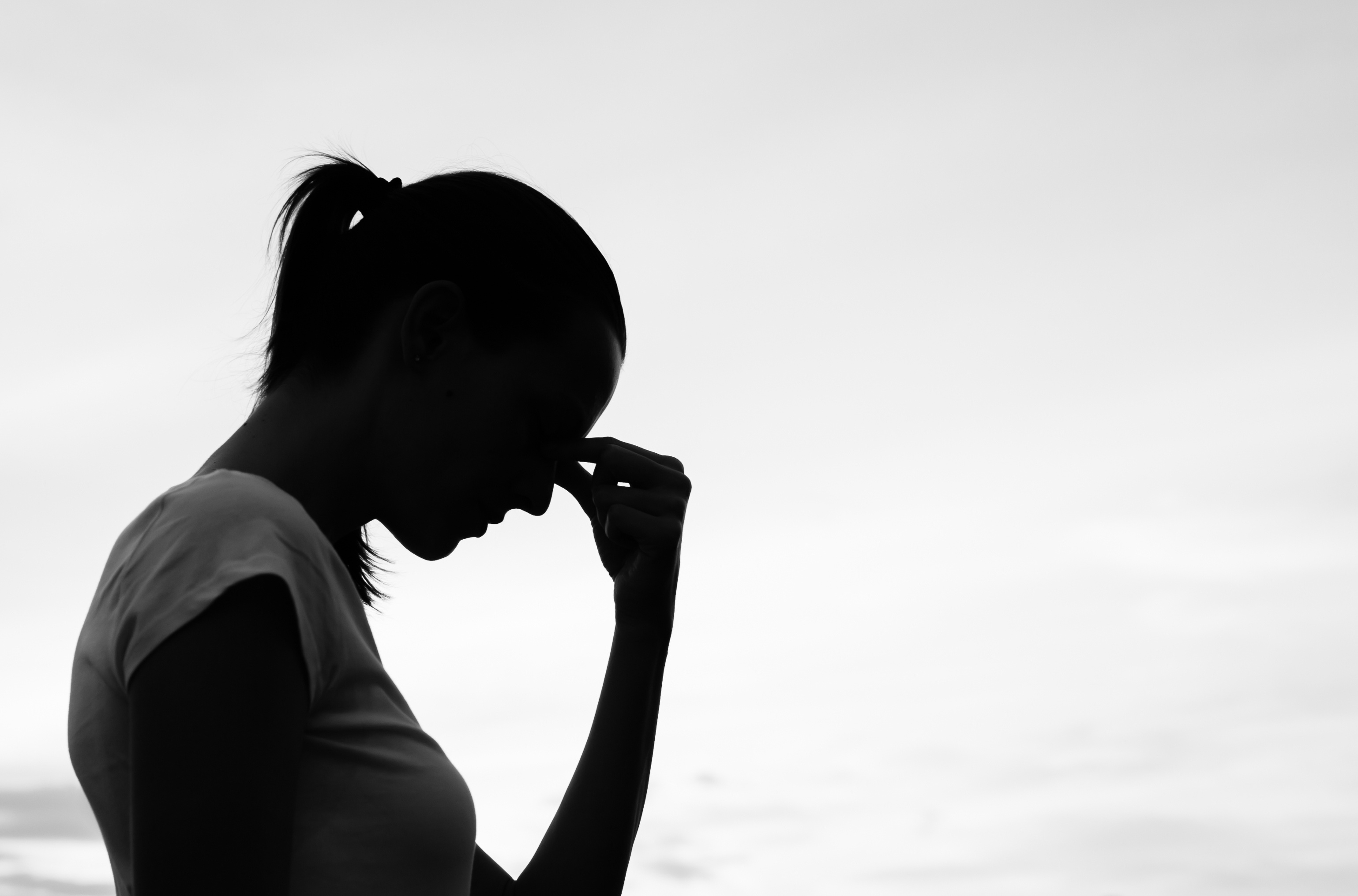 Despairing woman silhouette, Woman pinching nose bridge, Monochrome overcast sky, HD Desktop wallpaper