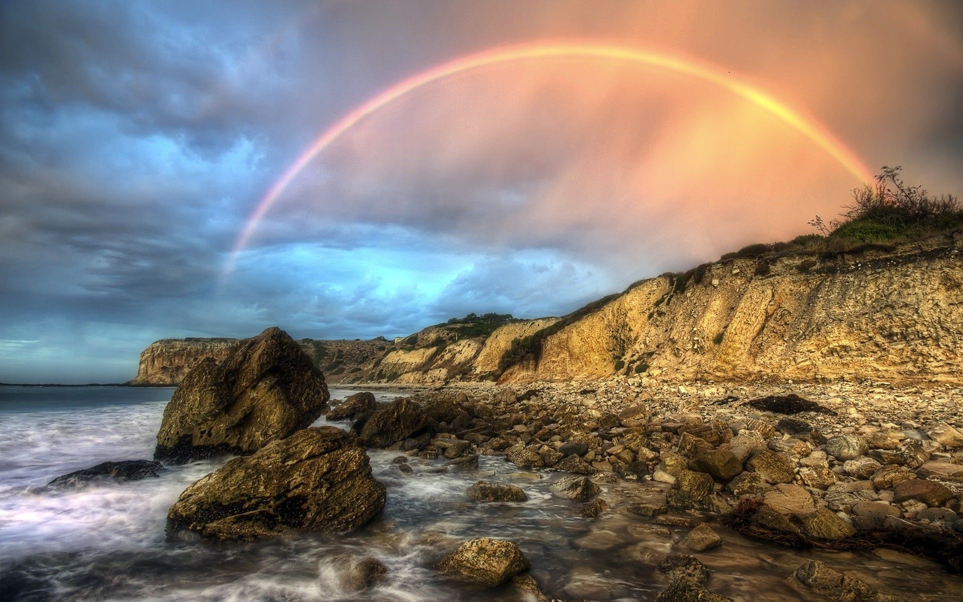 Arching ocean rainbow, Rocky coastal shoreline, Eroded sea cliffs, HD Desktop wallpaper
