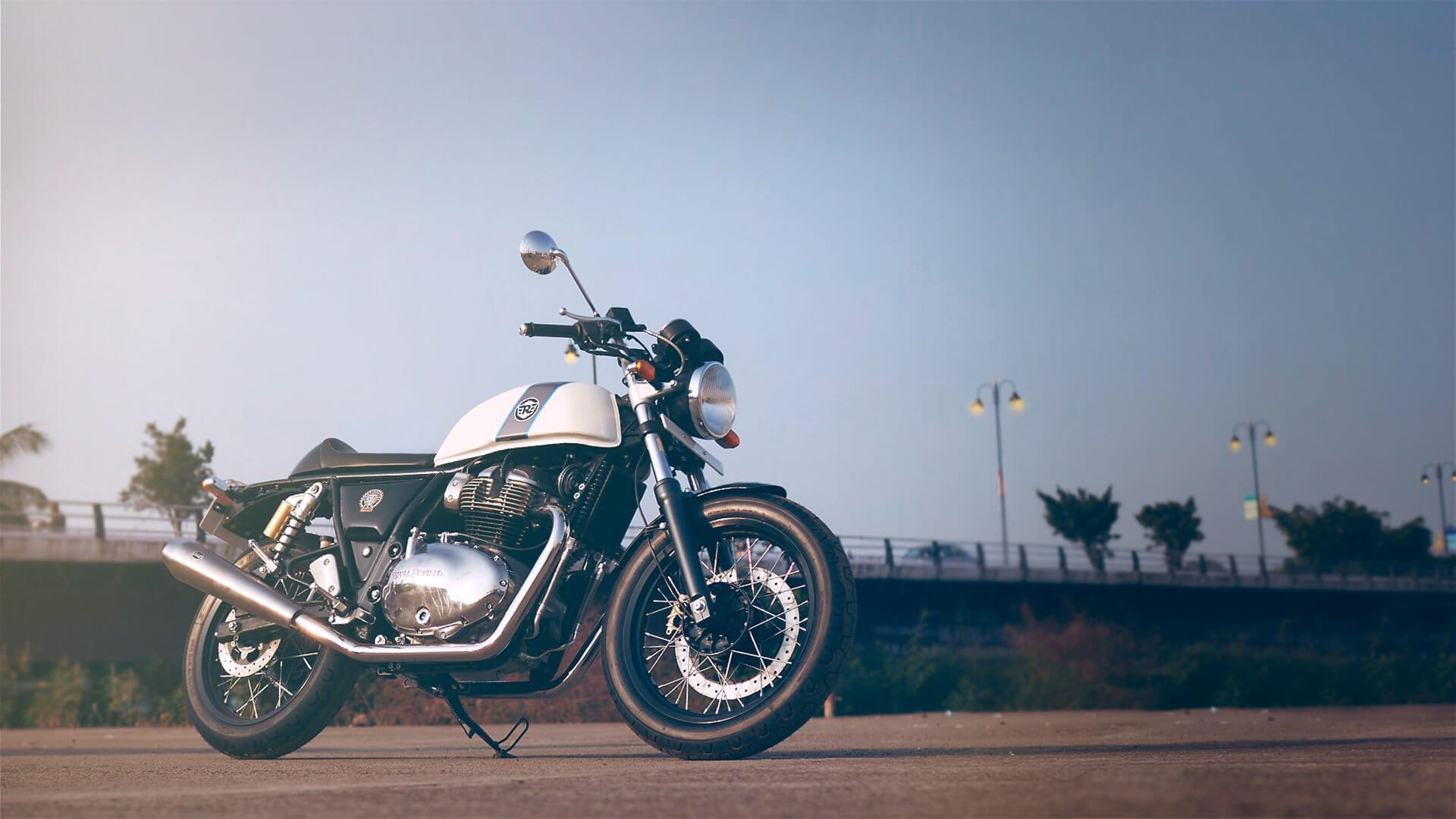 Royal Enfield Continental GT 650, Chrome exhaust and spoke wheels, Paved roadside with streetlights, Full HD Desktop wallpaper