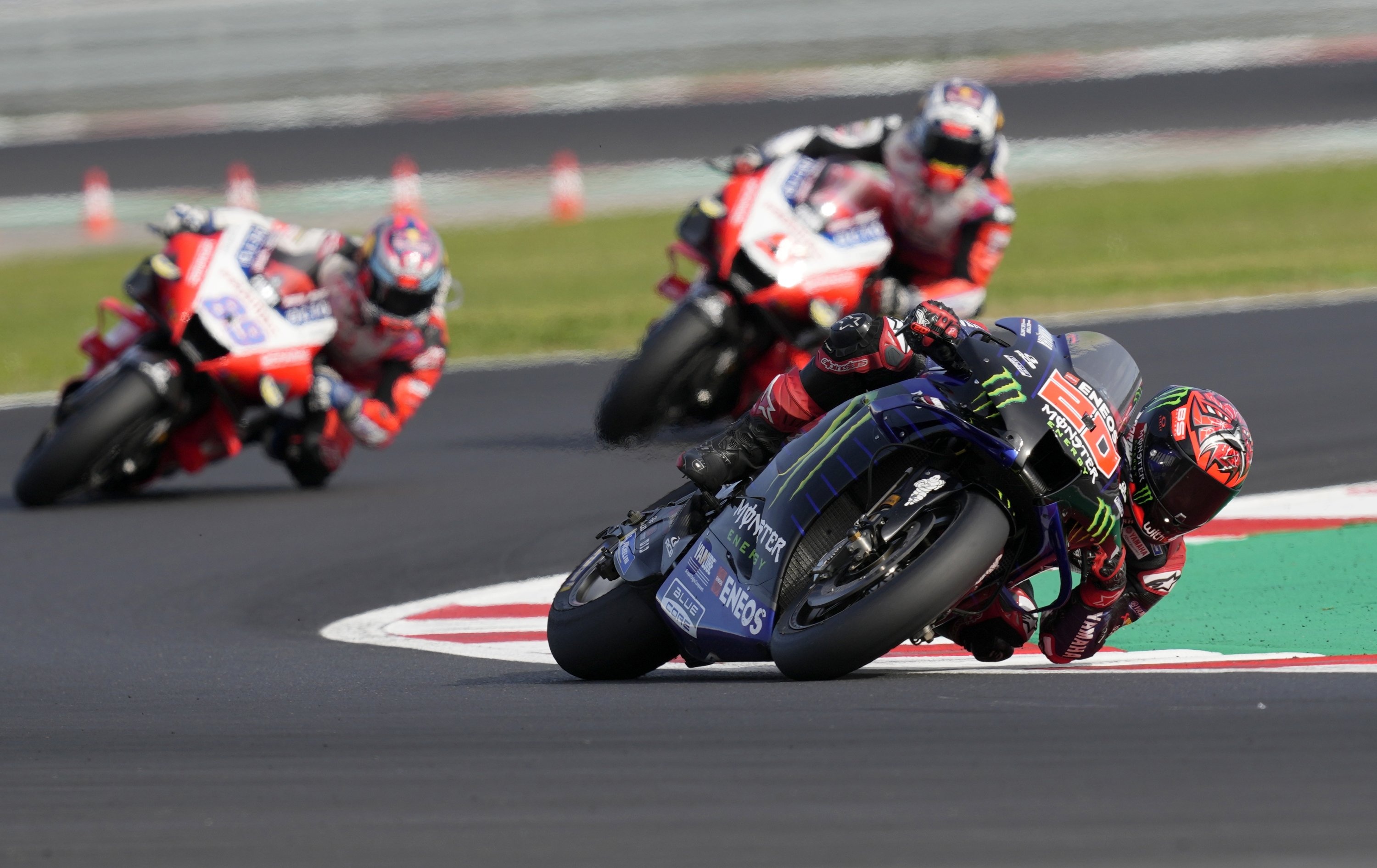 Fabio Quartararo number 20, Monster Energy Yamaha YZR-M1, Pramac Ducati pair chasing, MotoGP corner red kerb, HD Desktop wallpaper