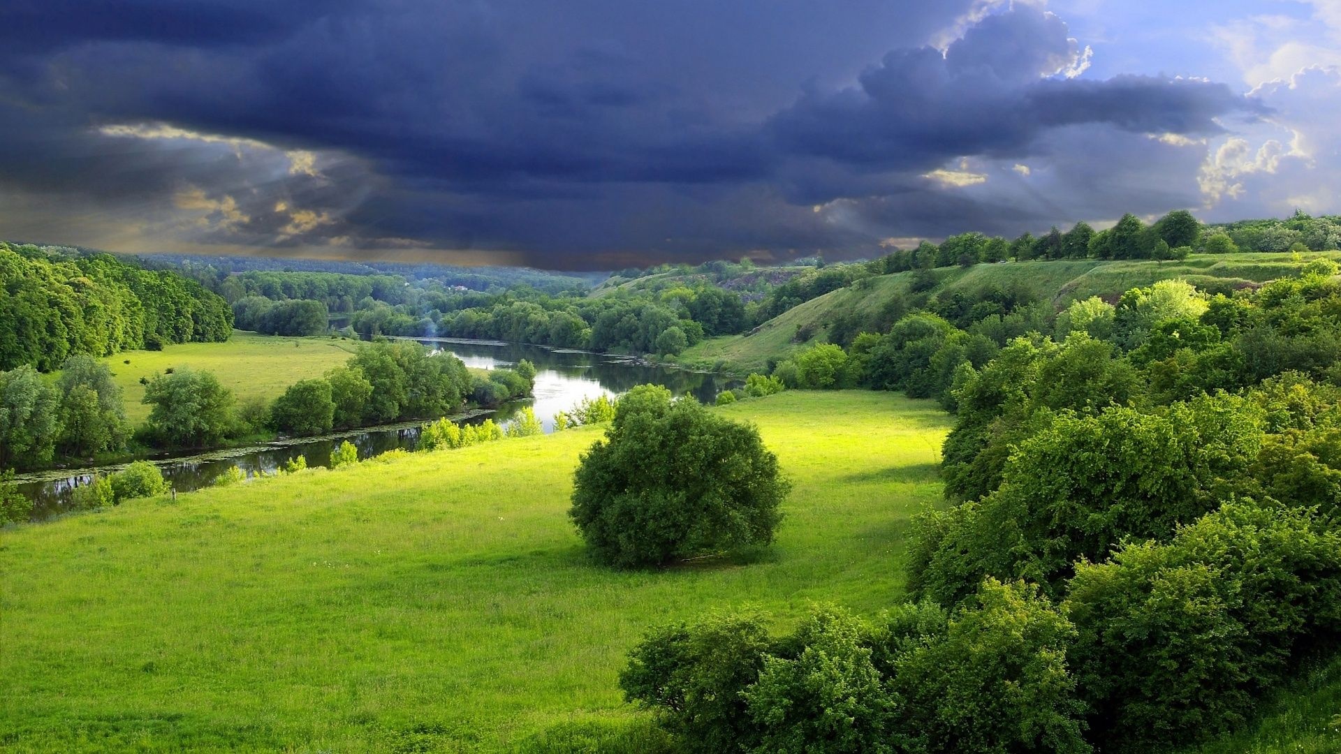 meandering river valley, rolling green meadow, dark storm clouds, Full HD Desktop wallpaper