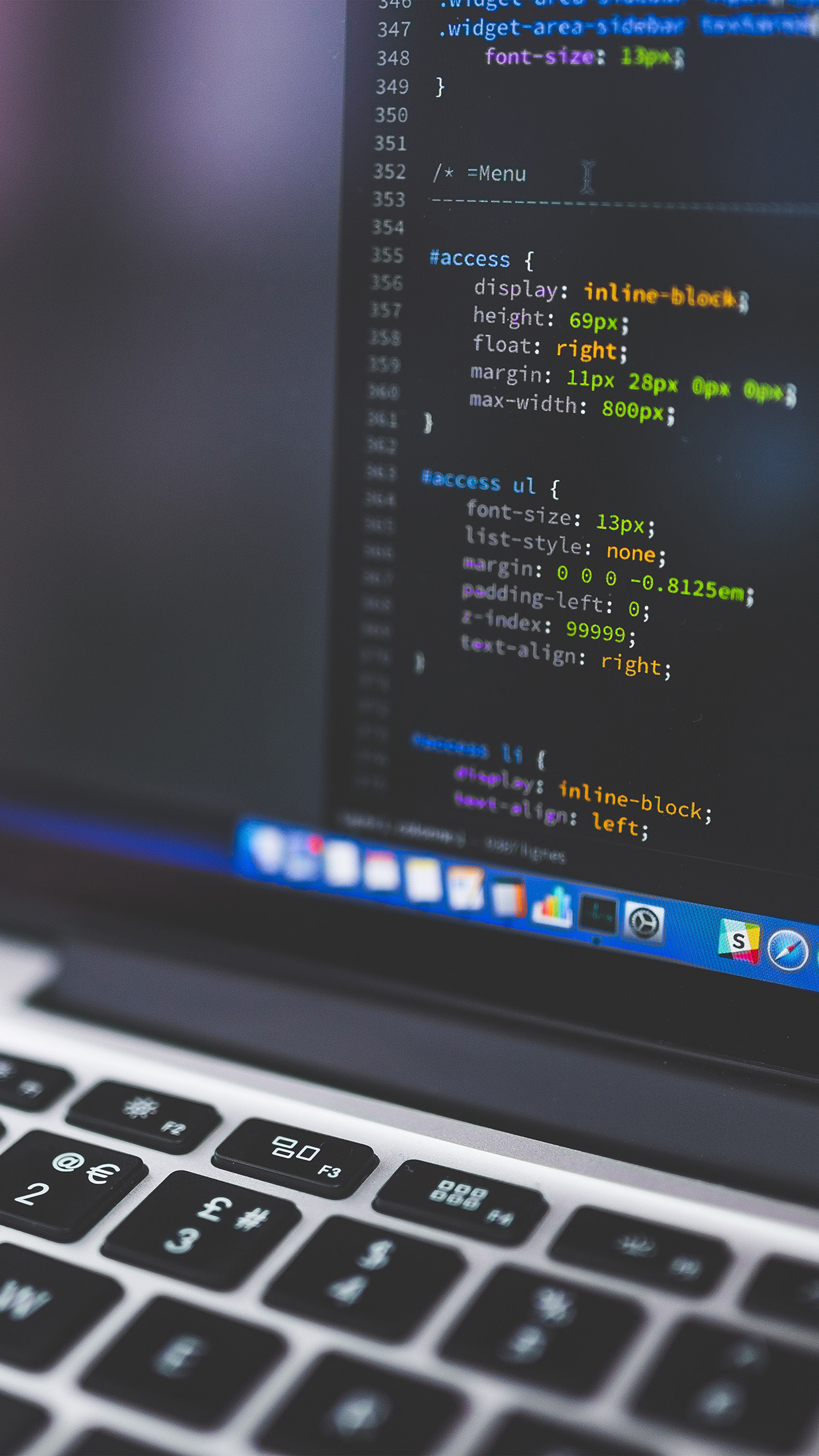 CSS code on screen, MacBook keyboard, macOS dock, HD Phone wallpaper
