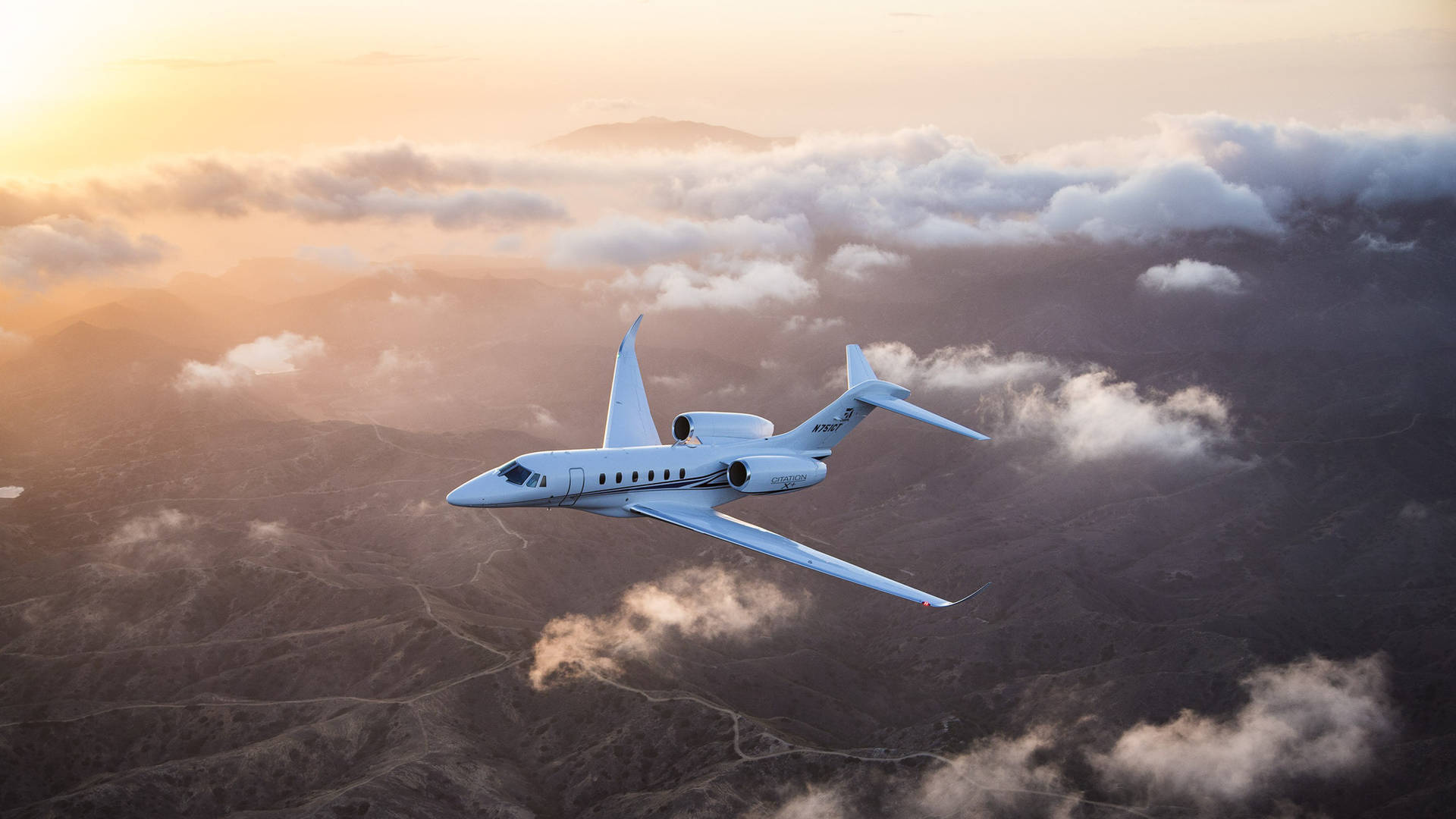 Cessna Citation X+, Mountain landscape with low clouds, Golden hour sunset glow, Full HD Desktop wallpaper