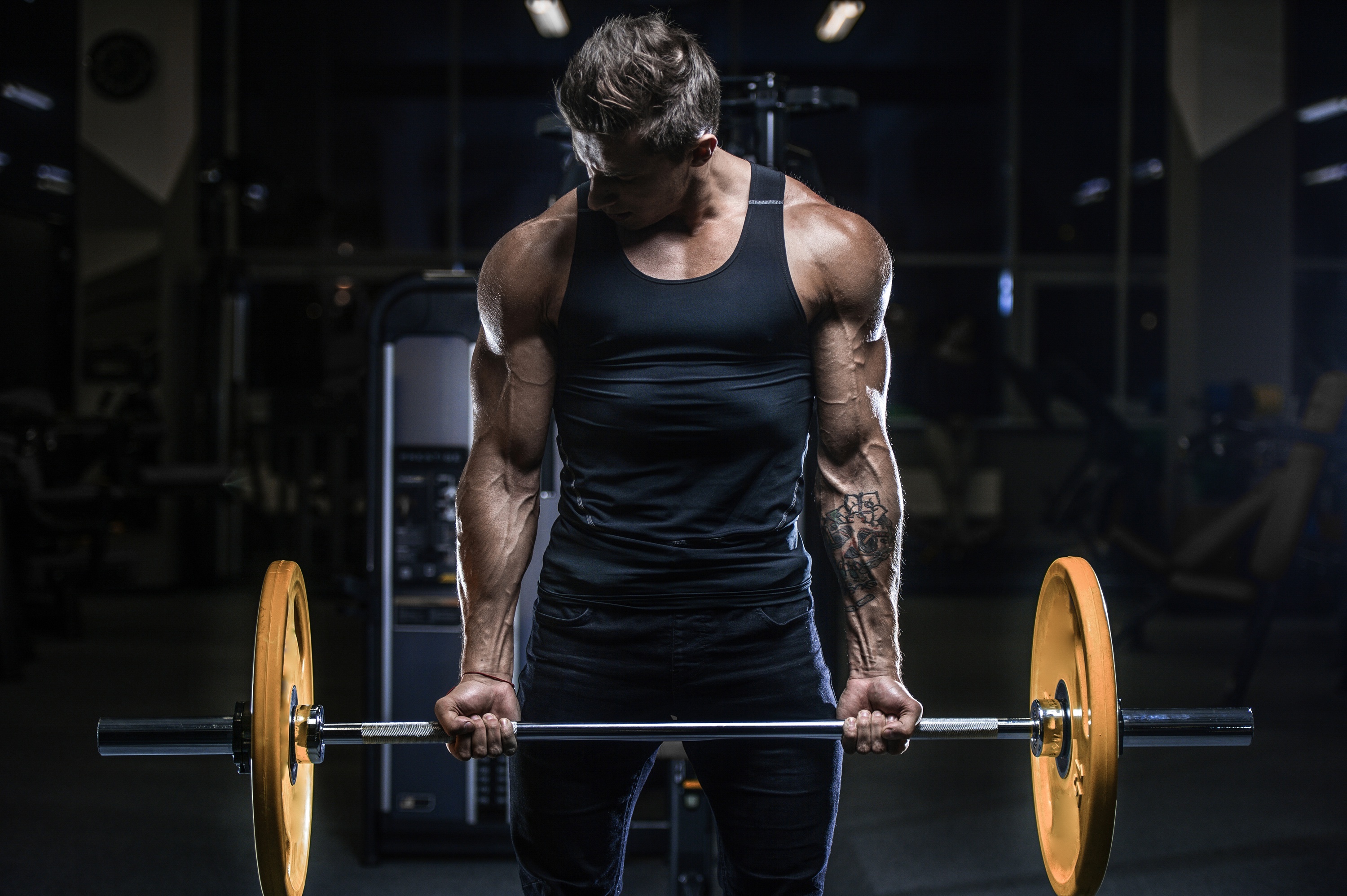 Muscular male bodybuilder, Yellow bumper plate barbell, Dark gym workout setting, HD Desktop wallpaper