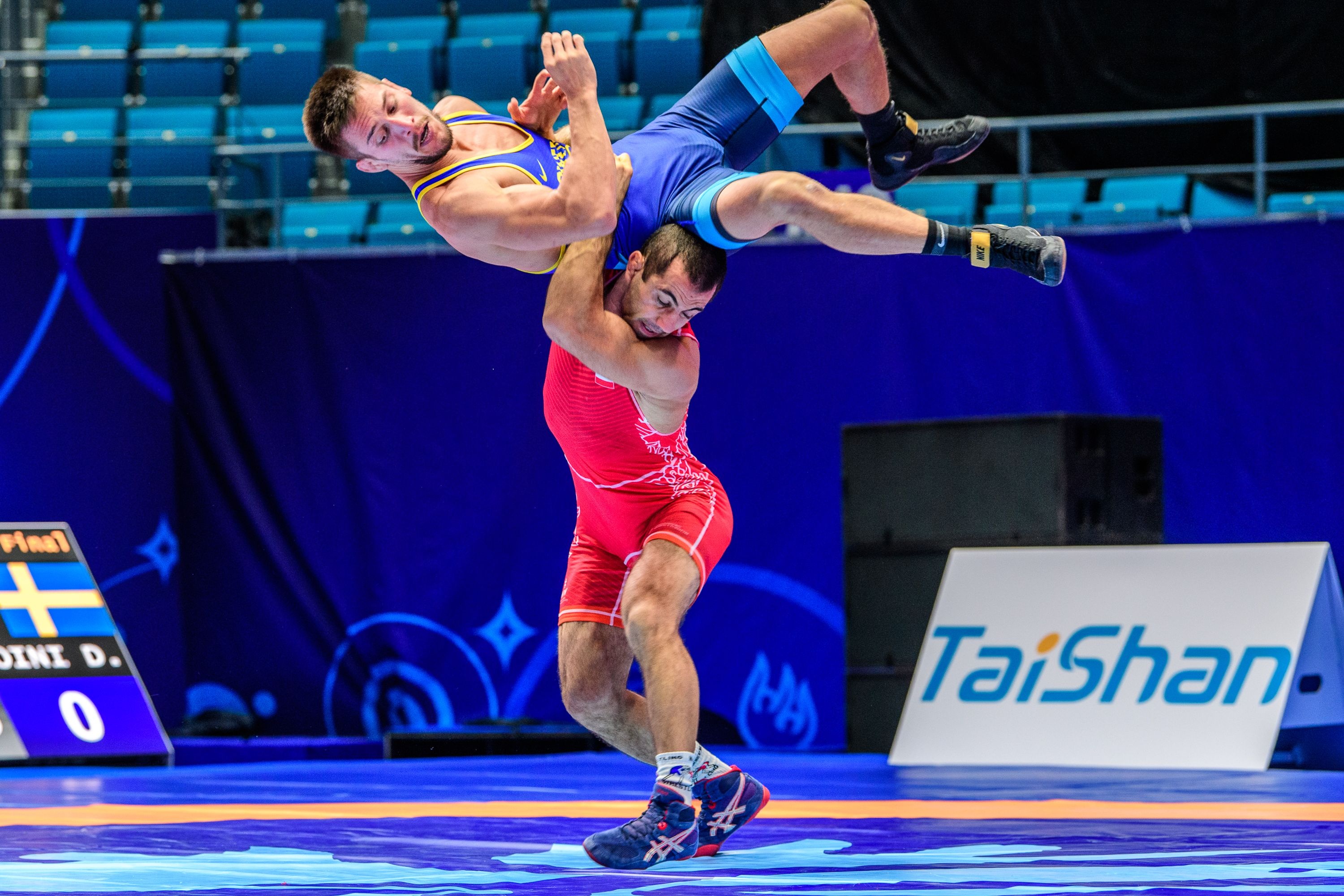 Gravity-defying wrestling throw, Olympic wrestling spectacle, Action-packed photography, Athletic prowess, 3000x2000 HD Desktop