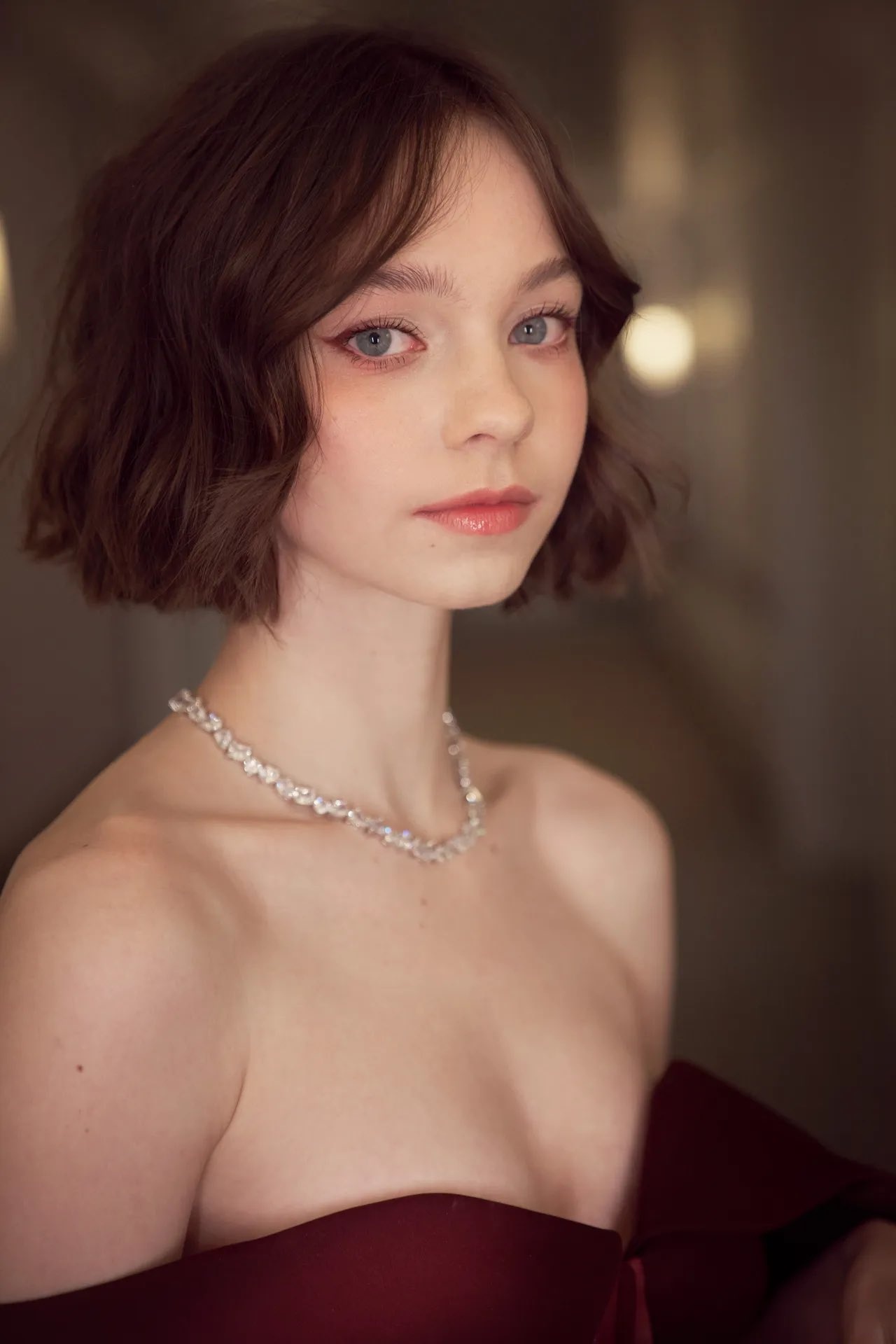 Emma Myers in burgundy gown, Crystal cluster necklace, Warm bokeh interior light, HD Phone wallpaper