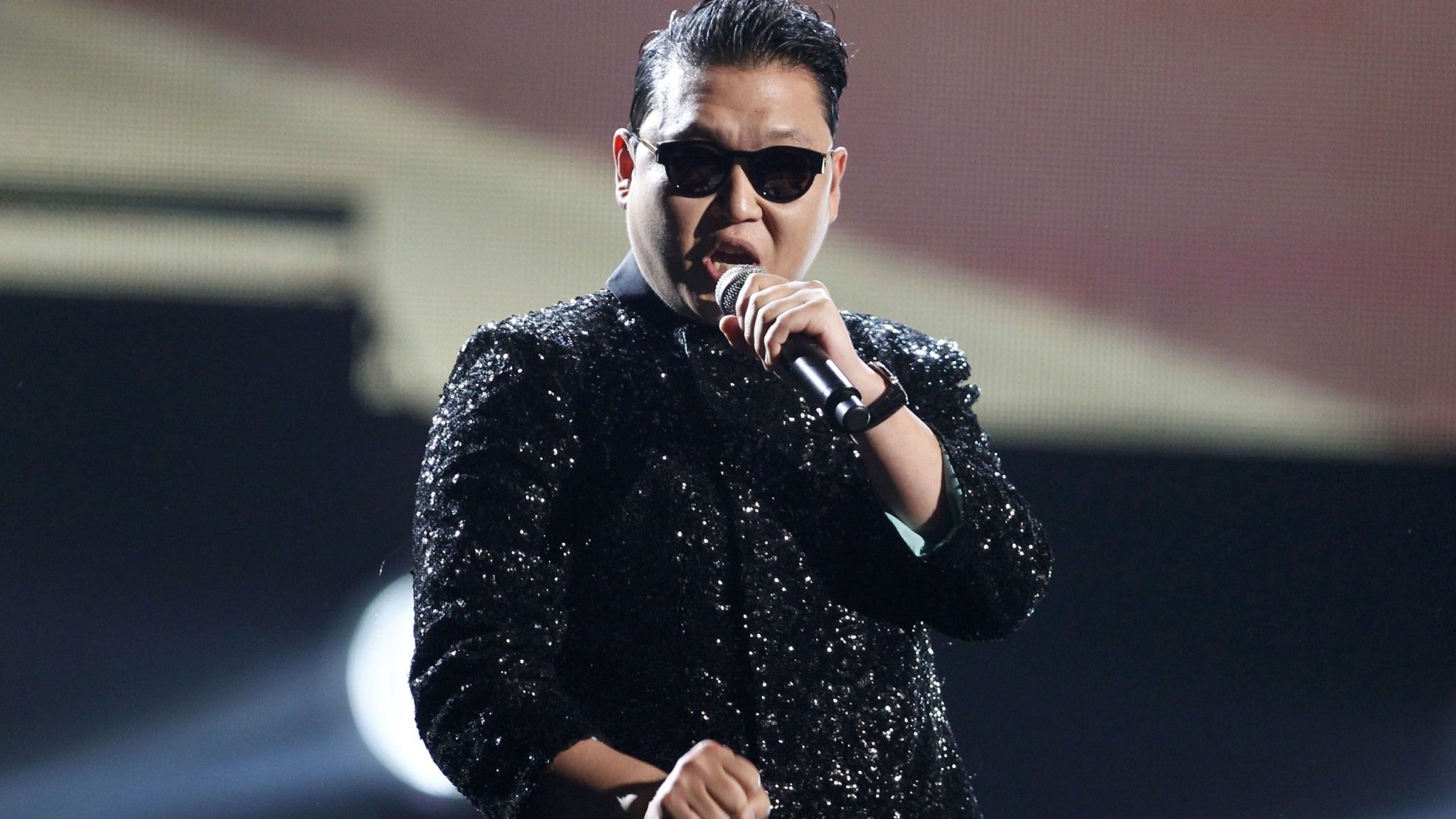 PSY wallpaper, K-pop concert scene, Energetic performer, Trendsetting icon, 2050x1160 HD Desktop