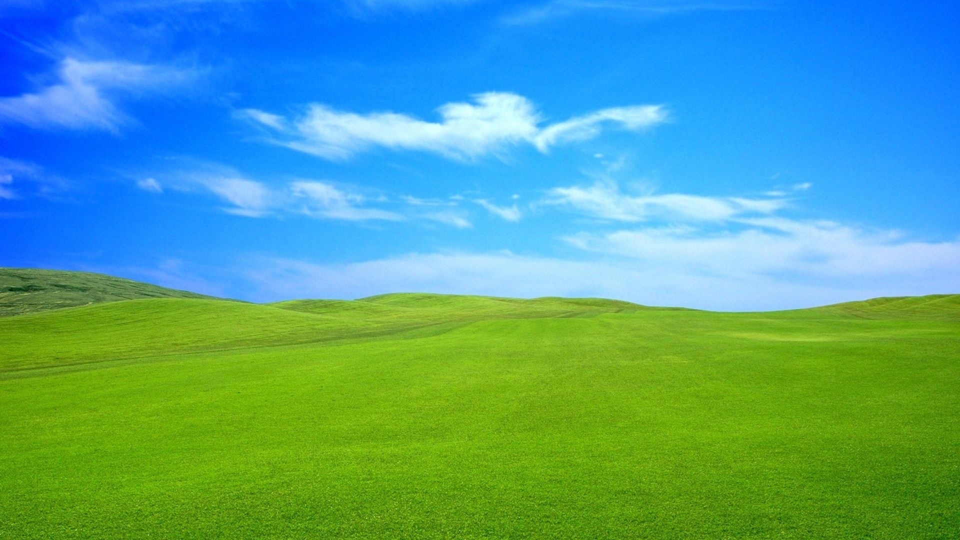 rolling green grassy hills, wispy white cirrus clouds, vibrant bright blue sky, Full HD Desktop wallpaper