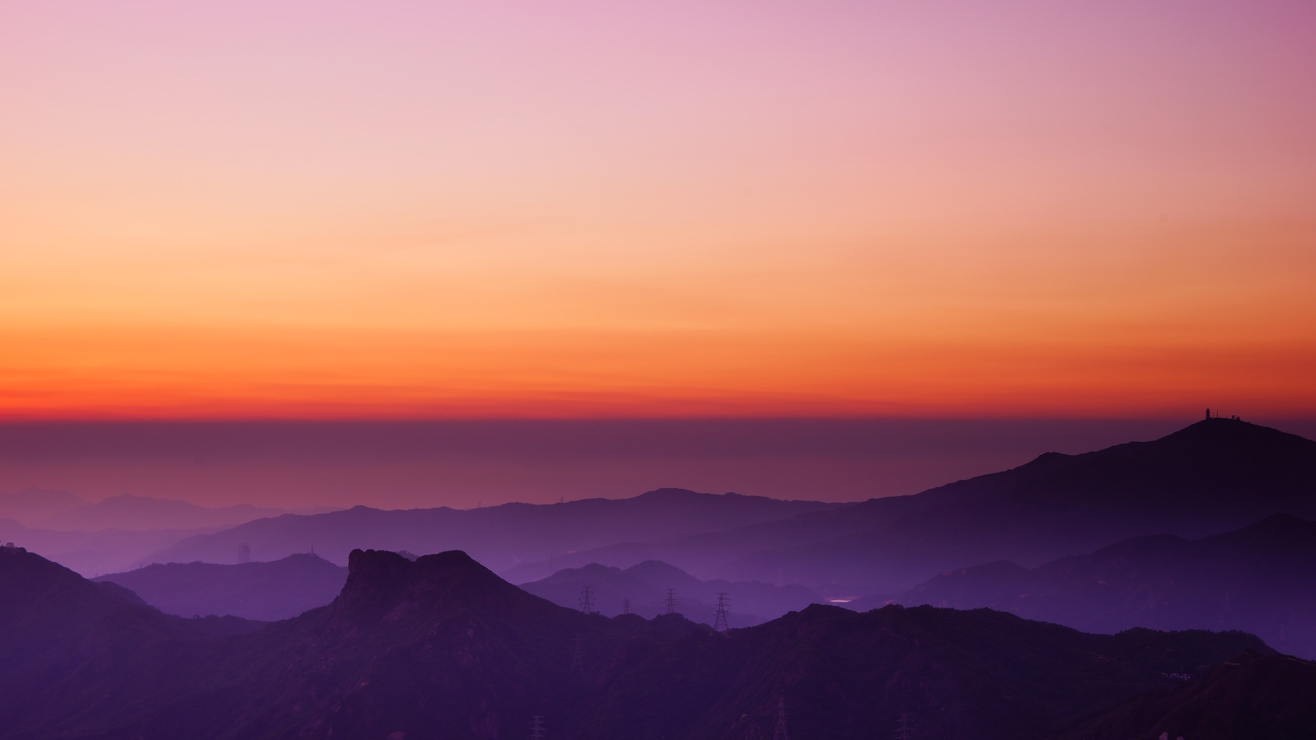 silhouetted mountain ridges, purple valley haze, orange gradient twilight sky, Full HD Desktop wallpaper