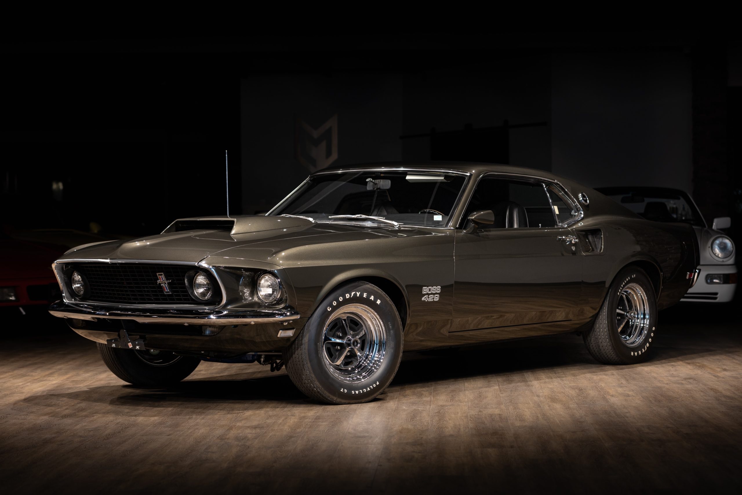 1969 Ford Mustang Boss 429, Goodyear Polyglas GT tires, Dark wood showroom floor, HD Desktop wallpaper