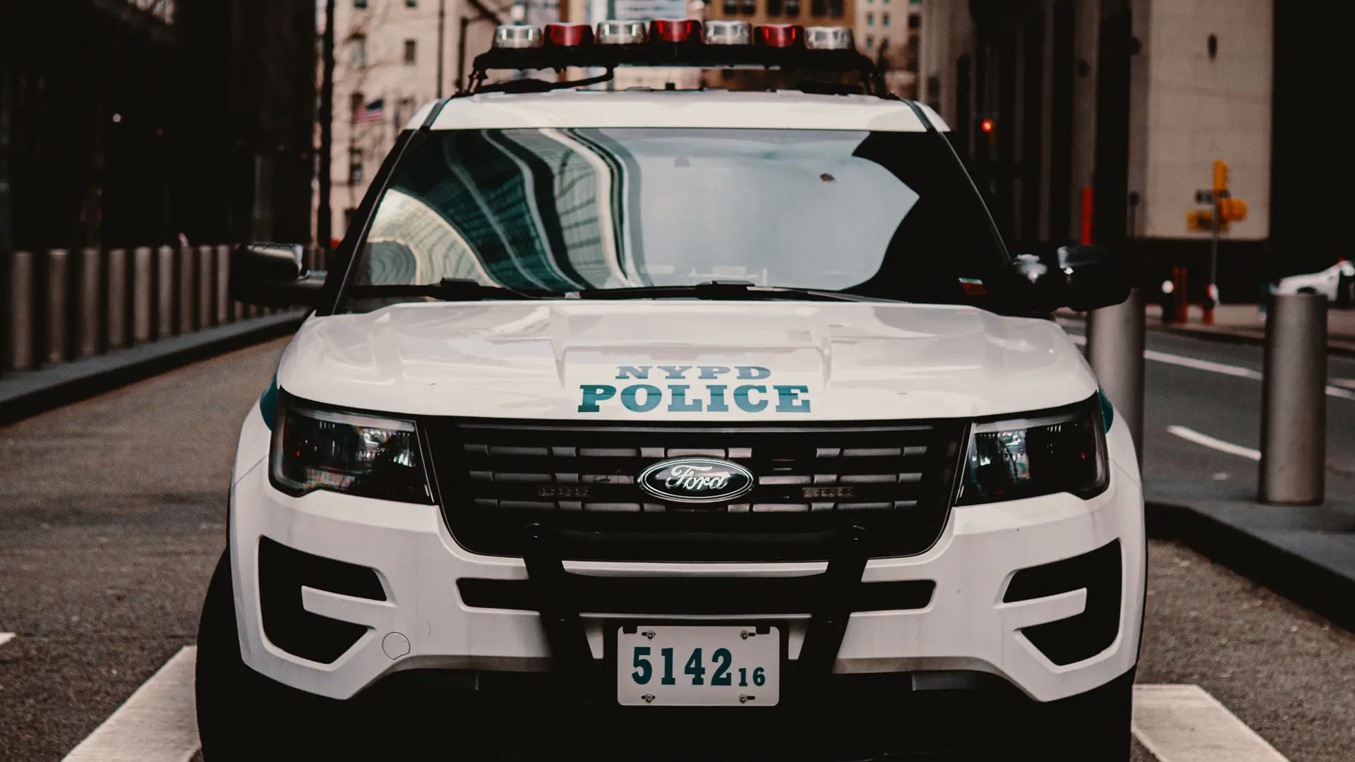 NYPD Ford Police Interceptor Utility, Rooftop emergency light bar, Urban street scene, Full HD Desktop wallpaper
