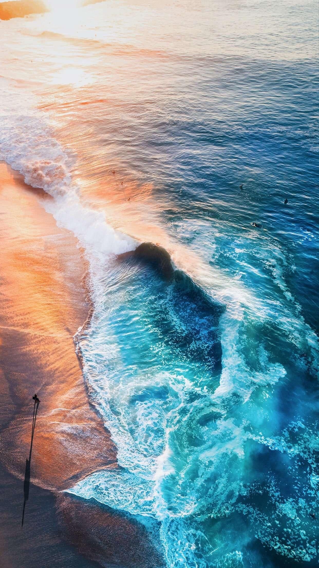 surfer casting long shadow, breaking turquoise ocean wave, golden hour sandy shoreline, HD Phone wallpaper