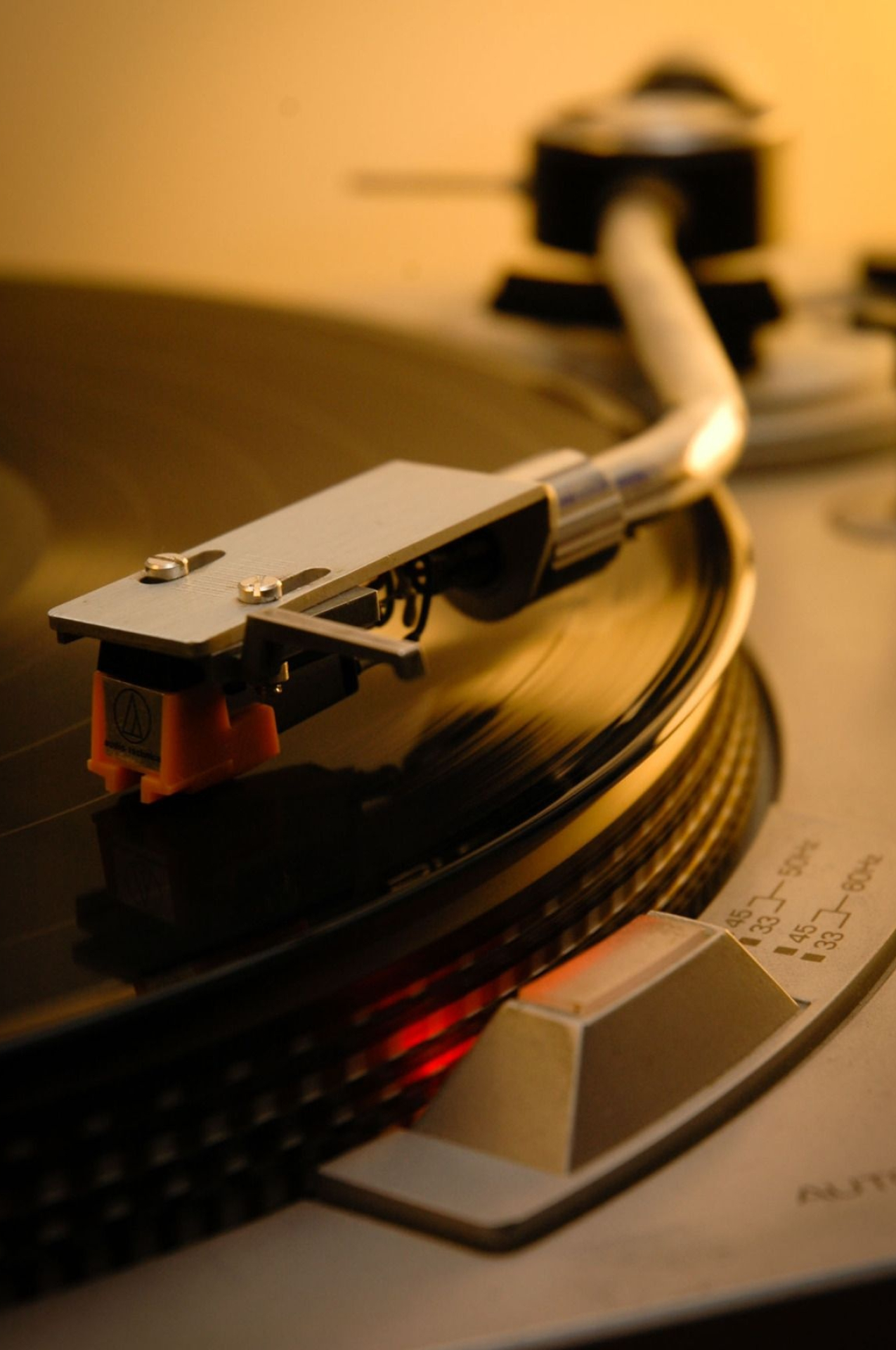 Audio-Technica cartridge, Turntable tonearm on vinyl, Warm amber lighting, HD Phone wallpaper