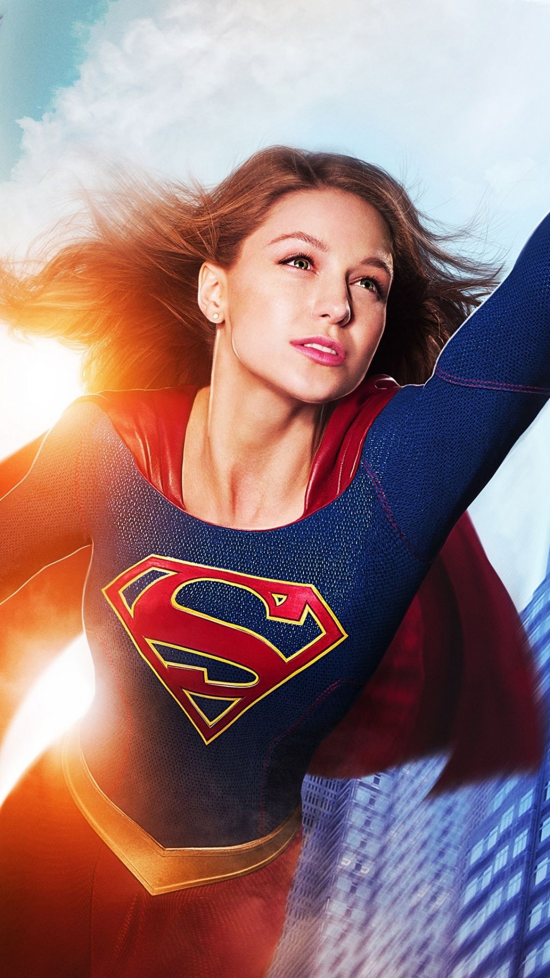 Melissa Benoist as Supergirl, House of El chest emblem, Sunlit National City skyline, Full HD Phone wallpaper