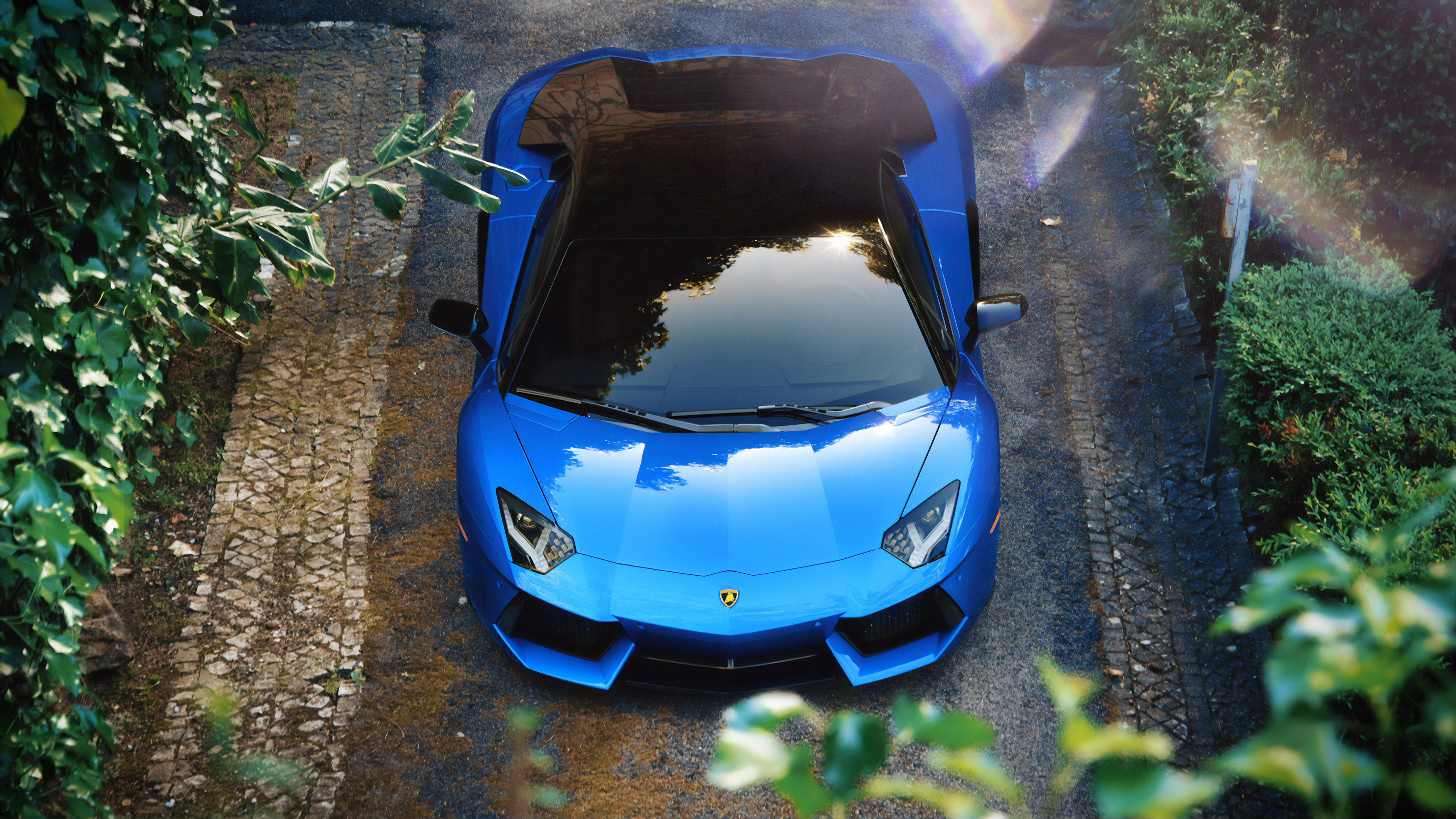 blue Lamborghini Aventador LP 700-4, cobblestone driveway, high angle overhead view, 4K Desktop wallpaper