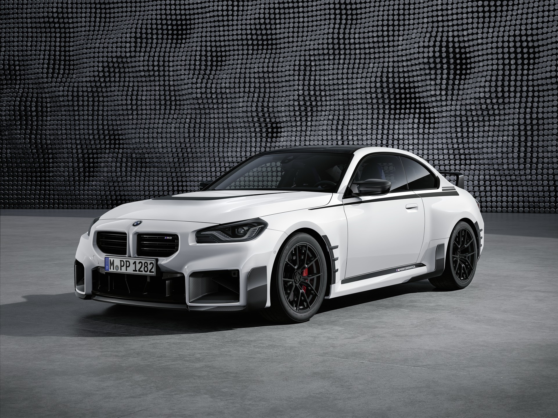 BMW M2 with M Performance Parts, Textured pegboard studio backdrop, Black lightweight alloy wheels, HD Desktop wallpaper