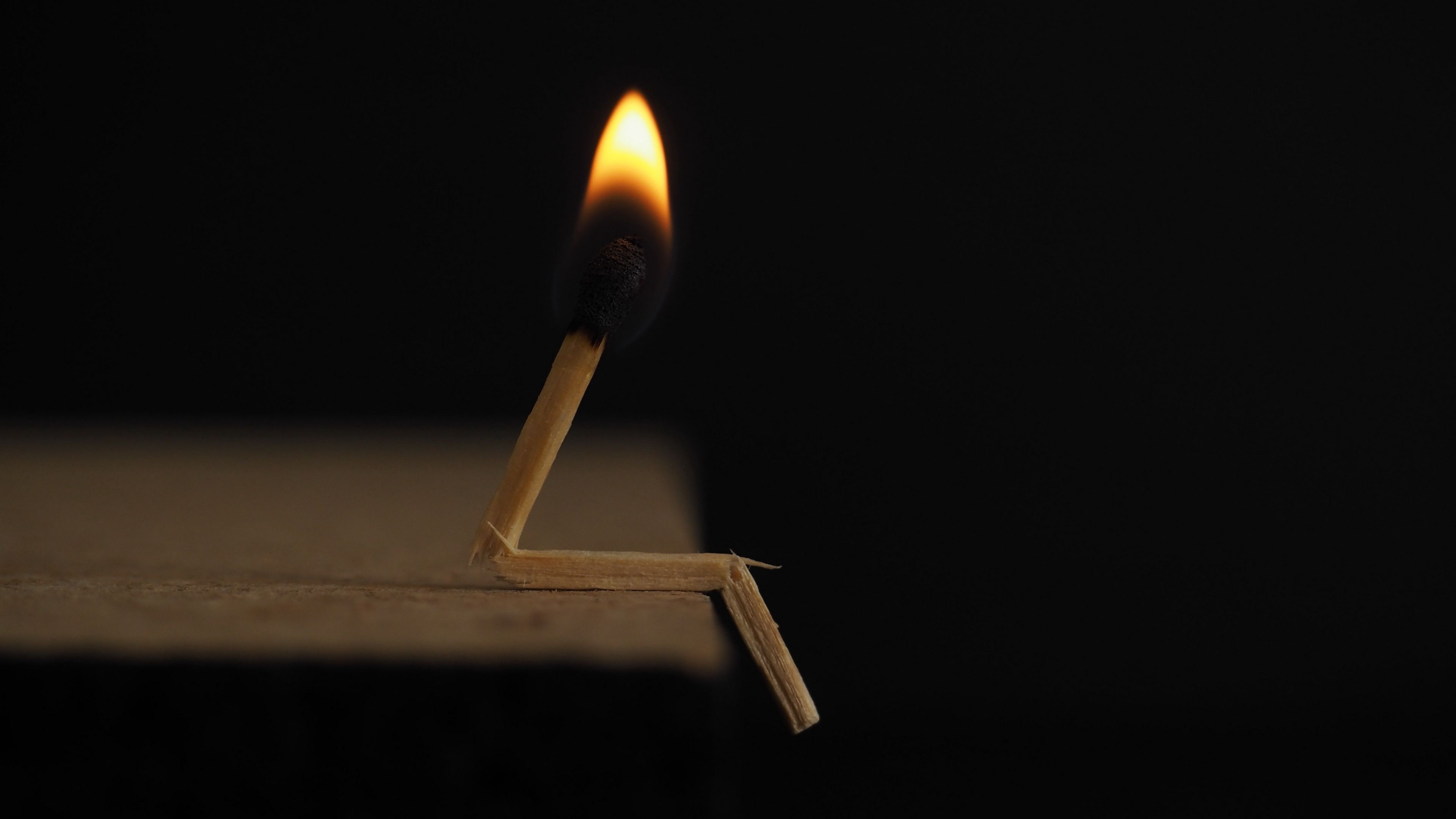 Seated burning matchstick, Yellow match flame, Black minimalist background, 4K Desktop wallpaper
