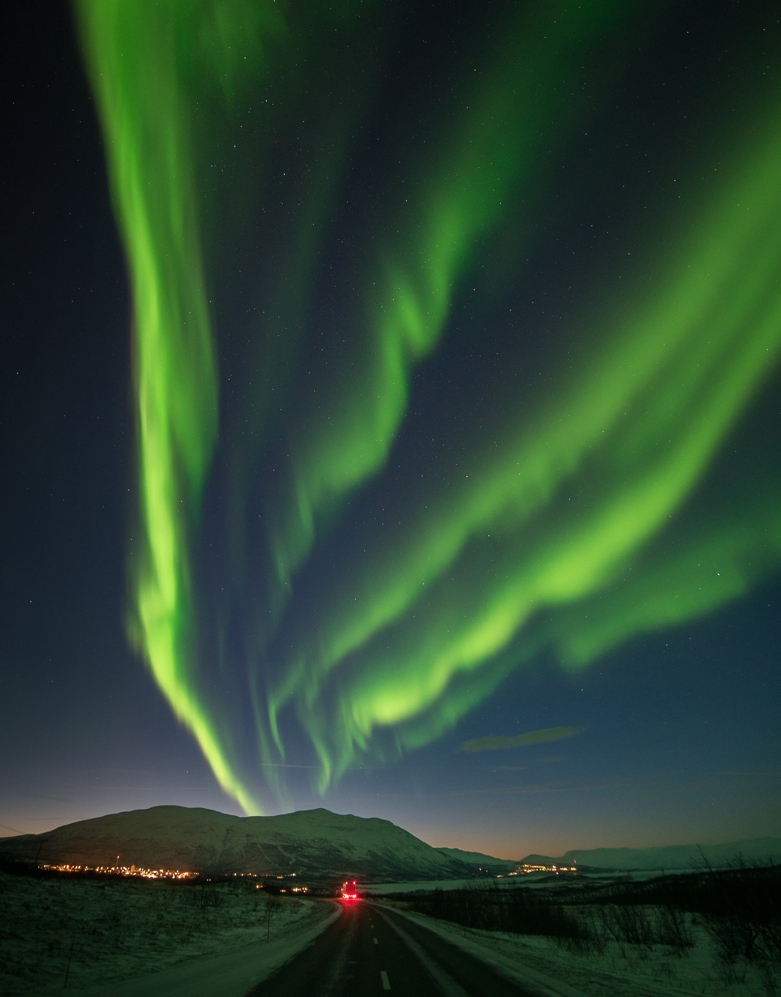 Green Aurora Borealis, Snowy Arctic highway, Snow-covered mountain range, HD Phone wallpaper