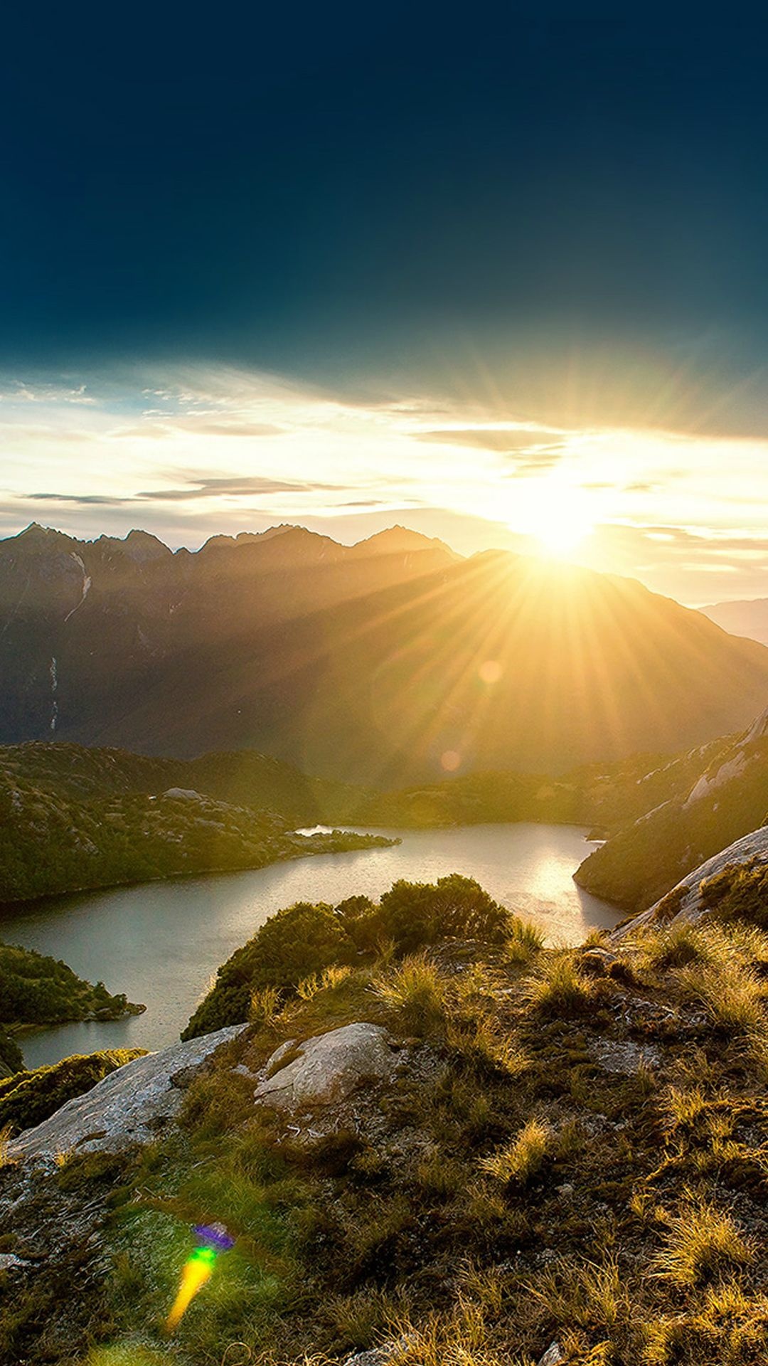 Mountain sunrise with sunburst, Alpine valley lake, Grassy alpine slopes, Full HD Phone wallpaper