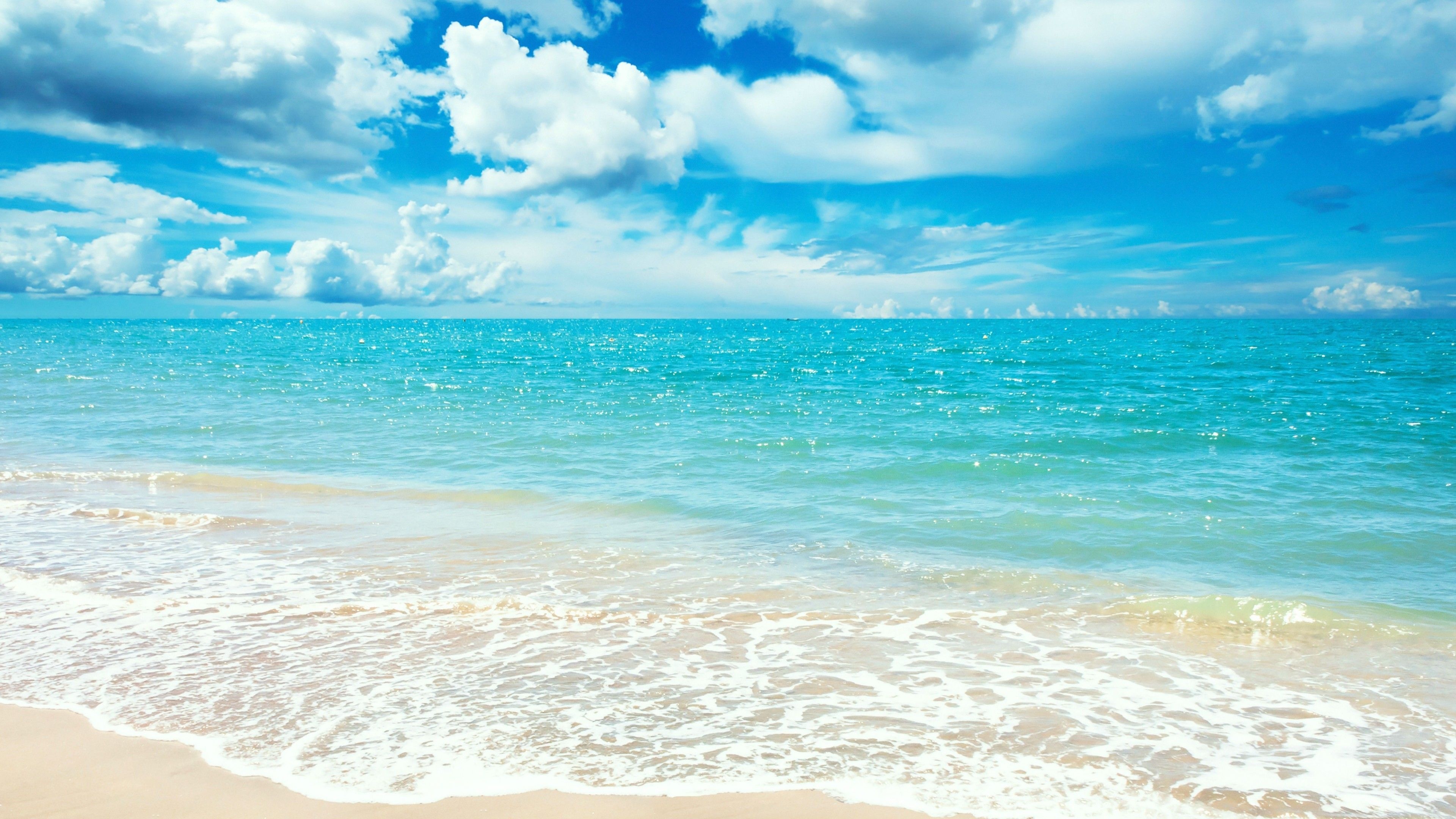 shimmering turquoise ocean, white foam beach surf, bright blue cumulus sky, 4K Desktop wallpaper