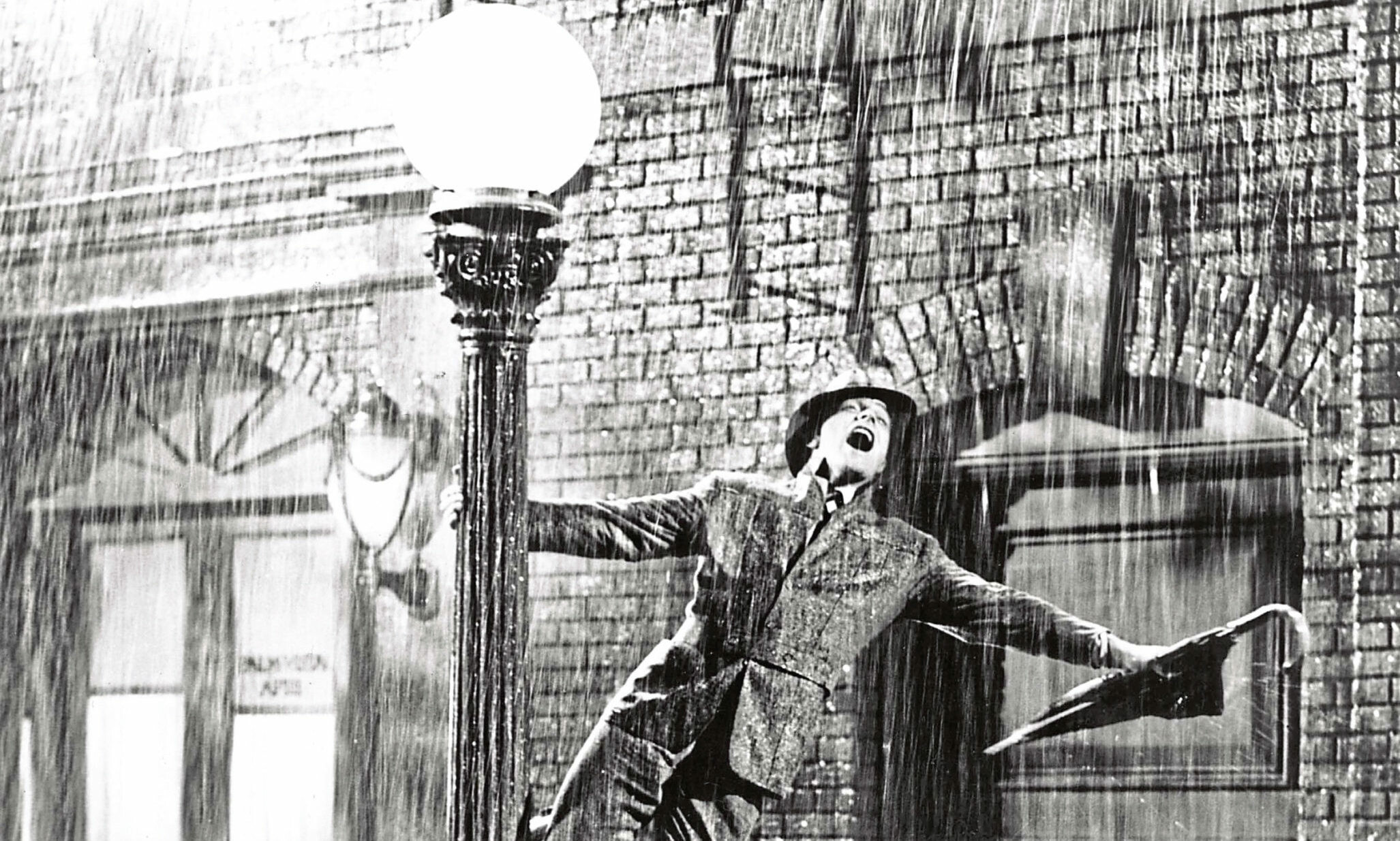 Musical magic, Gene Kelly's charm, Iconic umbrella scene, Filled with joy, 2060x1240 HD Desktop