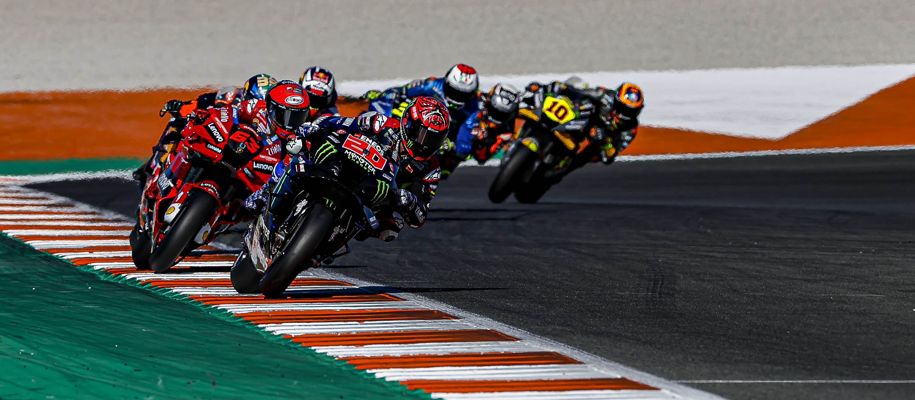 Fabio Quartararo number 20, Monster Energy Yamaha YZR-M1, MotoGP pack chasing behind, Orange gravel trap edge, Dual Screen Desktop wallpaper