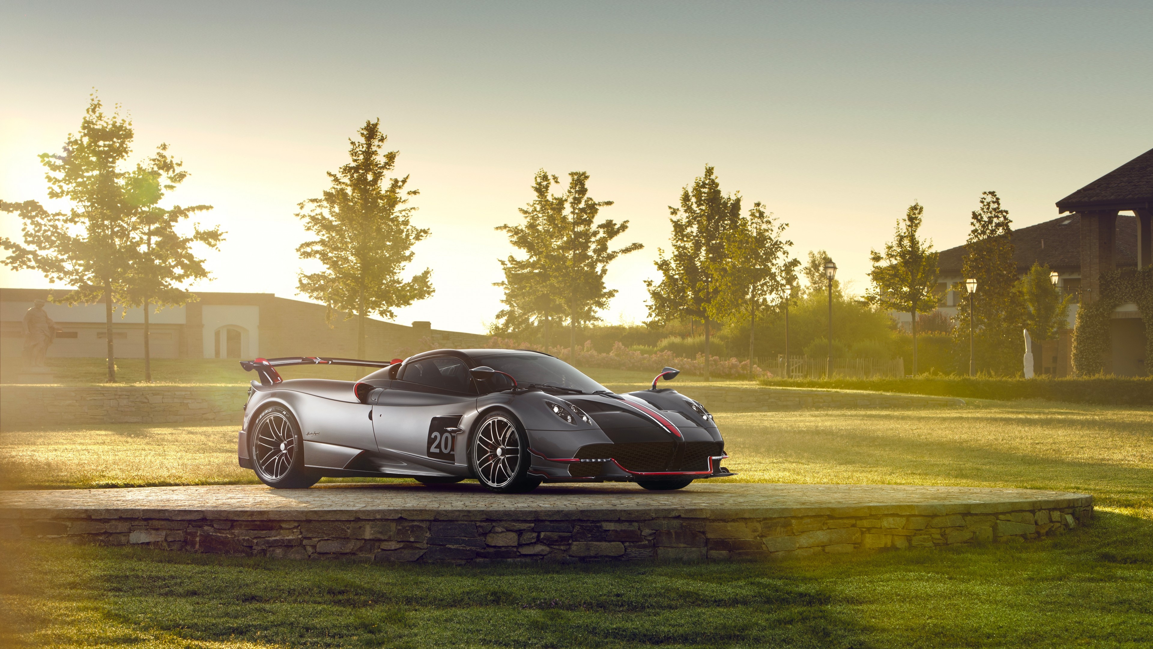 Pagani Huayra BC, elevated stone platform, golden hour sunlight, 4K Desktop wallpaper