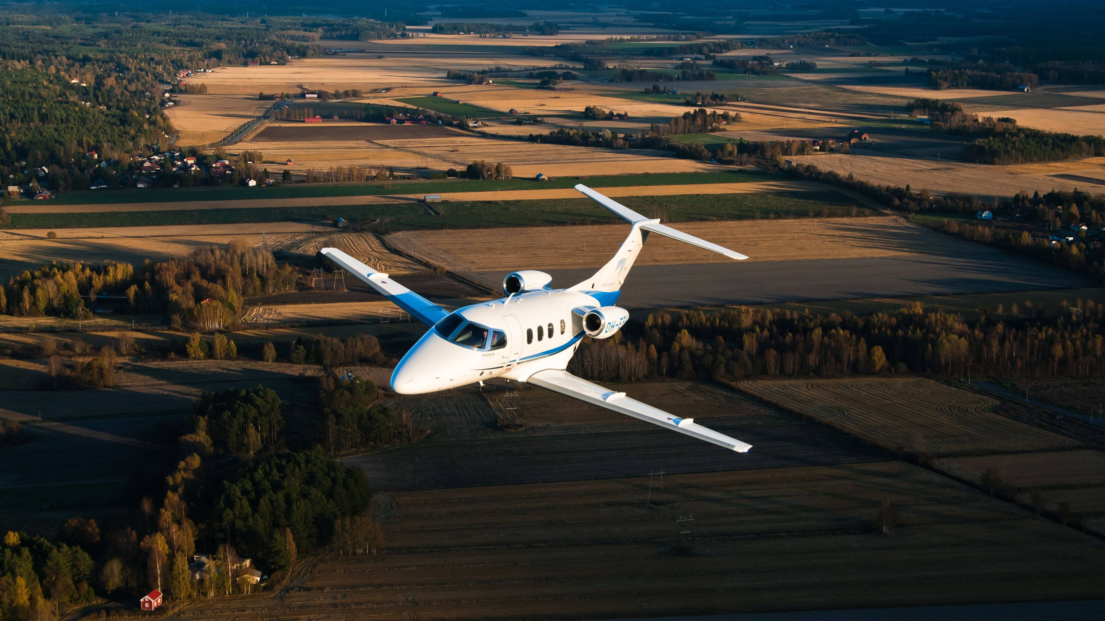 Embraer Phenom 100, Aerial view of farmland, Golden hour sunlight, 4K Desktop wallpaper