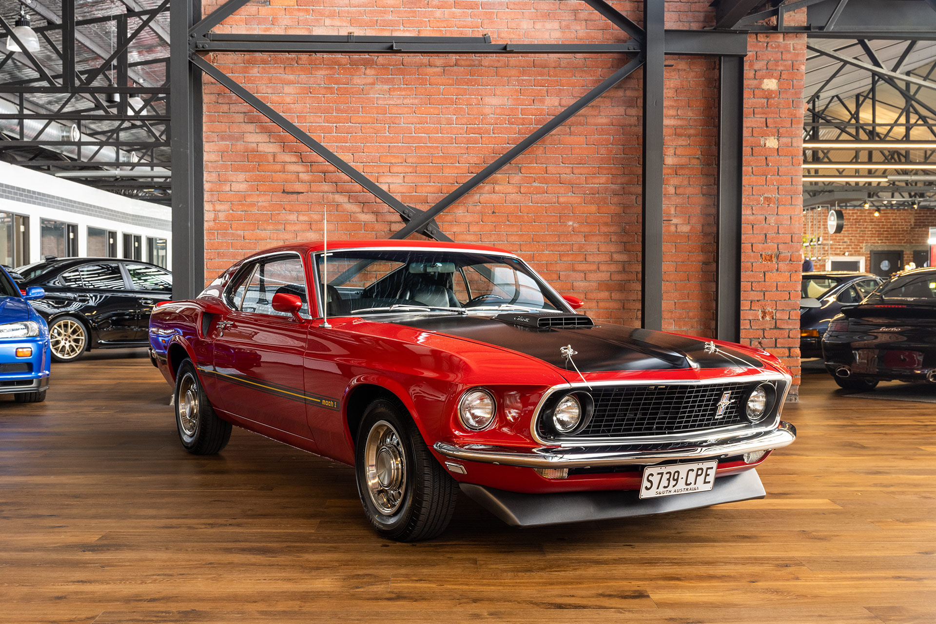 1969 Ford Mustang Mach 1, Exposed red brick wall, Polished wooden showroom floor, HD Desktop wallpaper