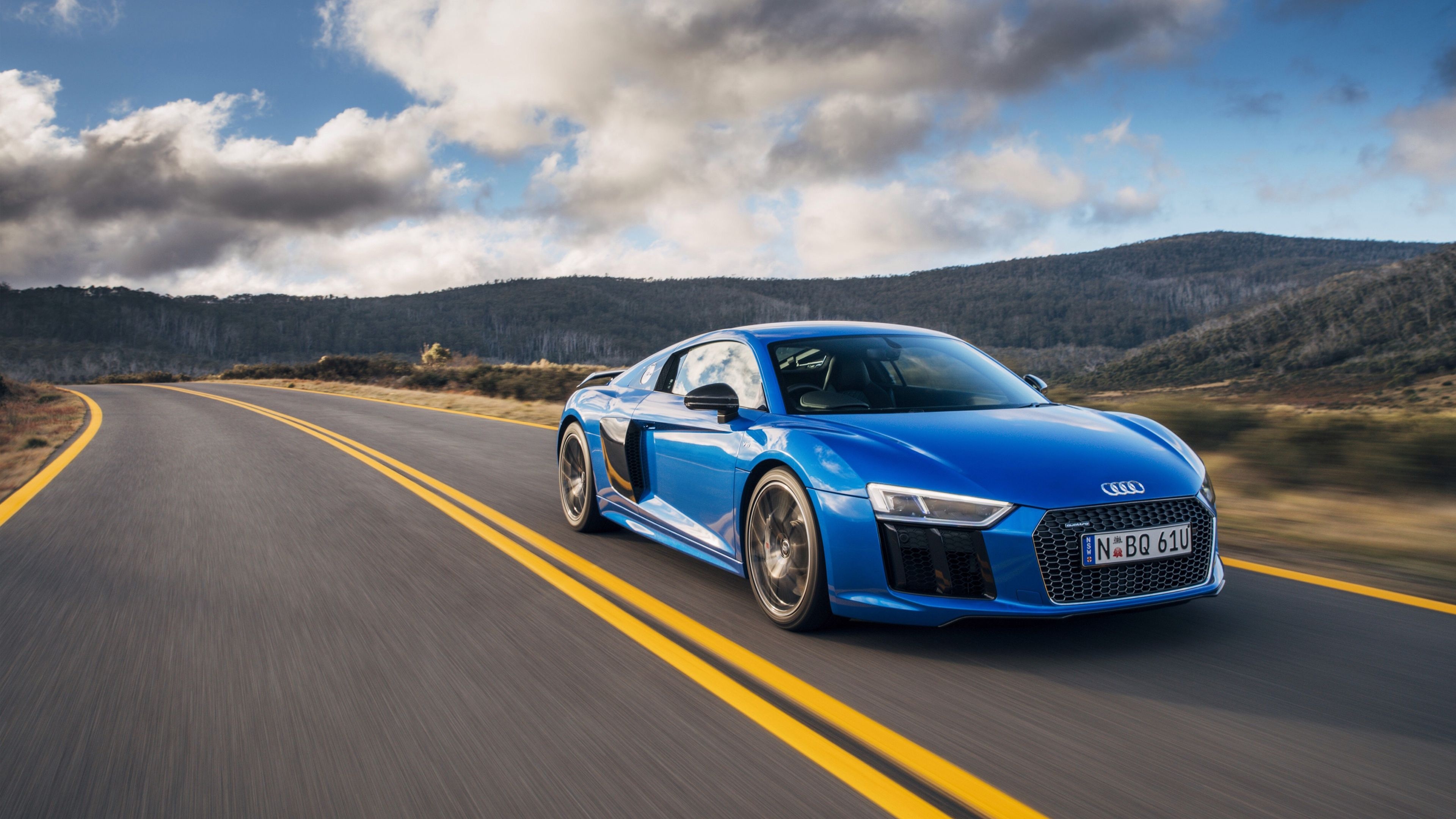 blue Audi R8 V10 Plus, curved asphalt highway, forested mountain landscape, 4K Desktop wallpaper